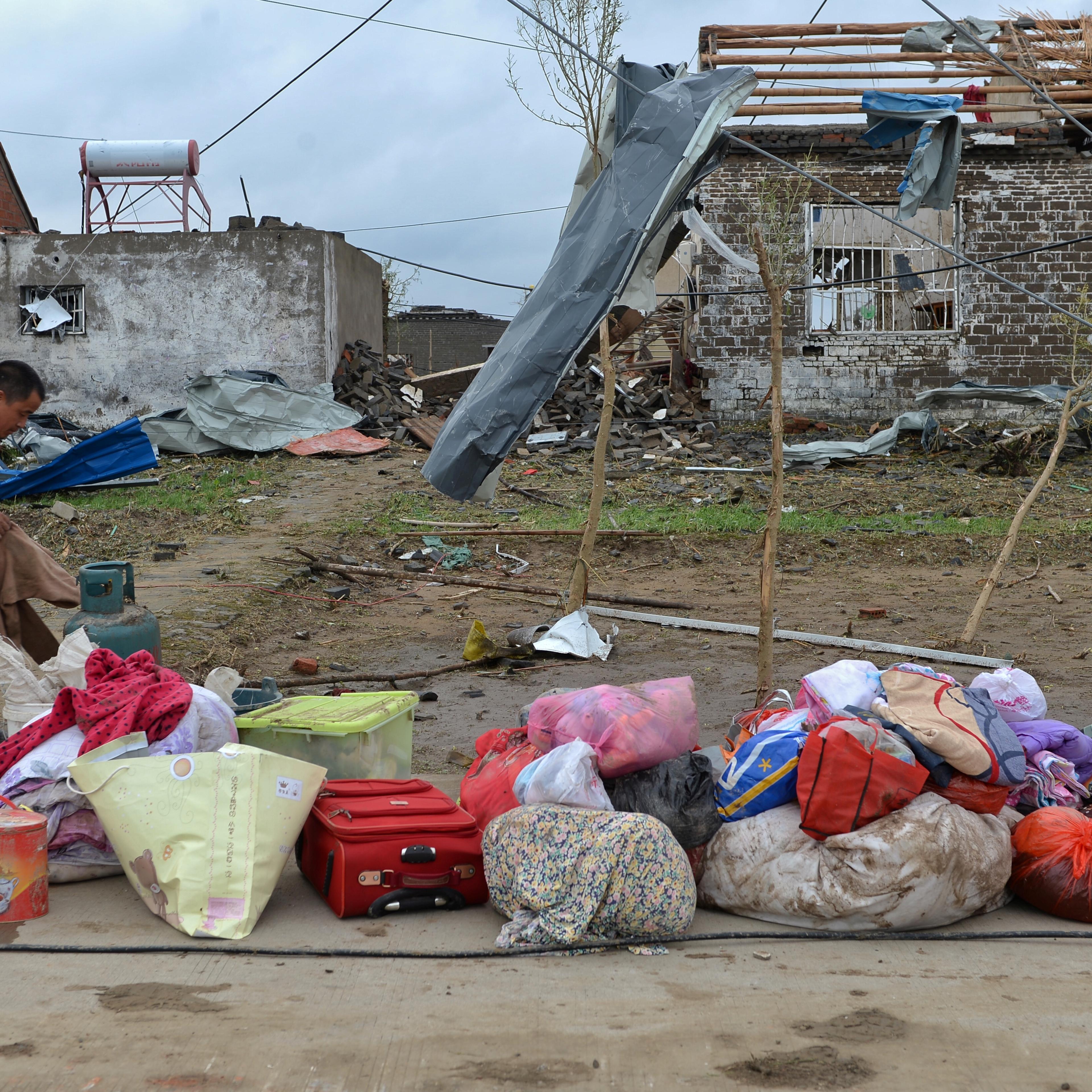 A men takes out his belongings from his damaged house after a tornado hit Funing on Thursday, in Yancheng