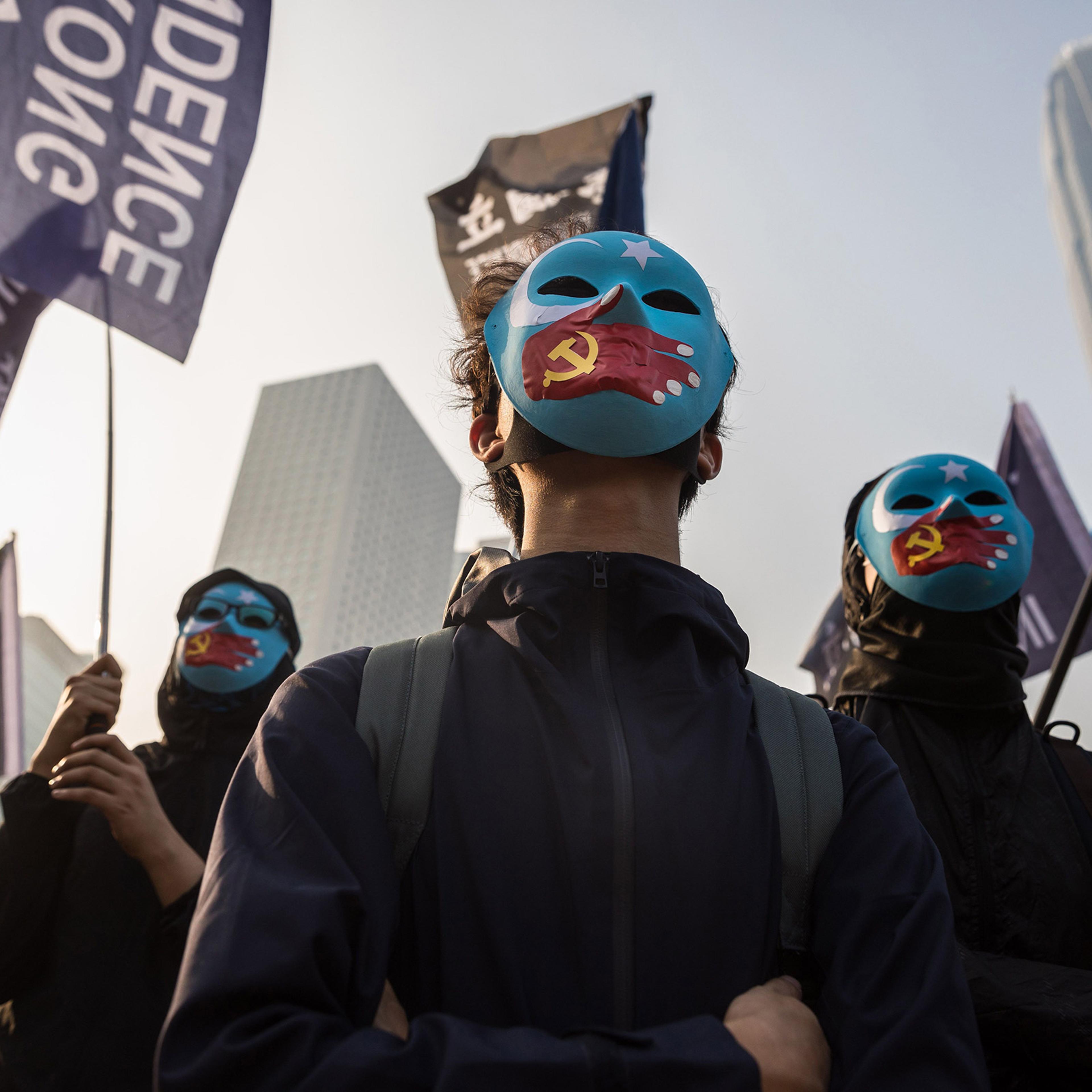 Protesters attend a rally in Hong Kong to show support for the Uighur minority in China