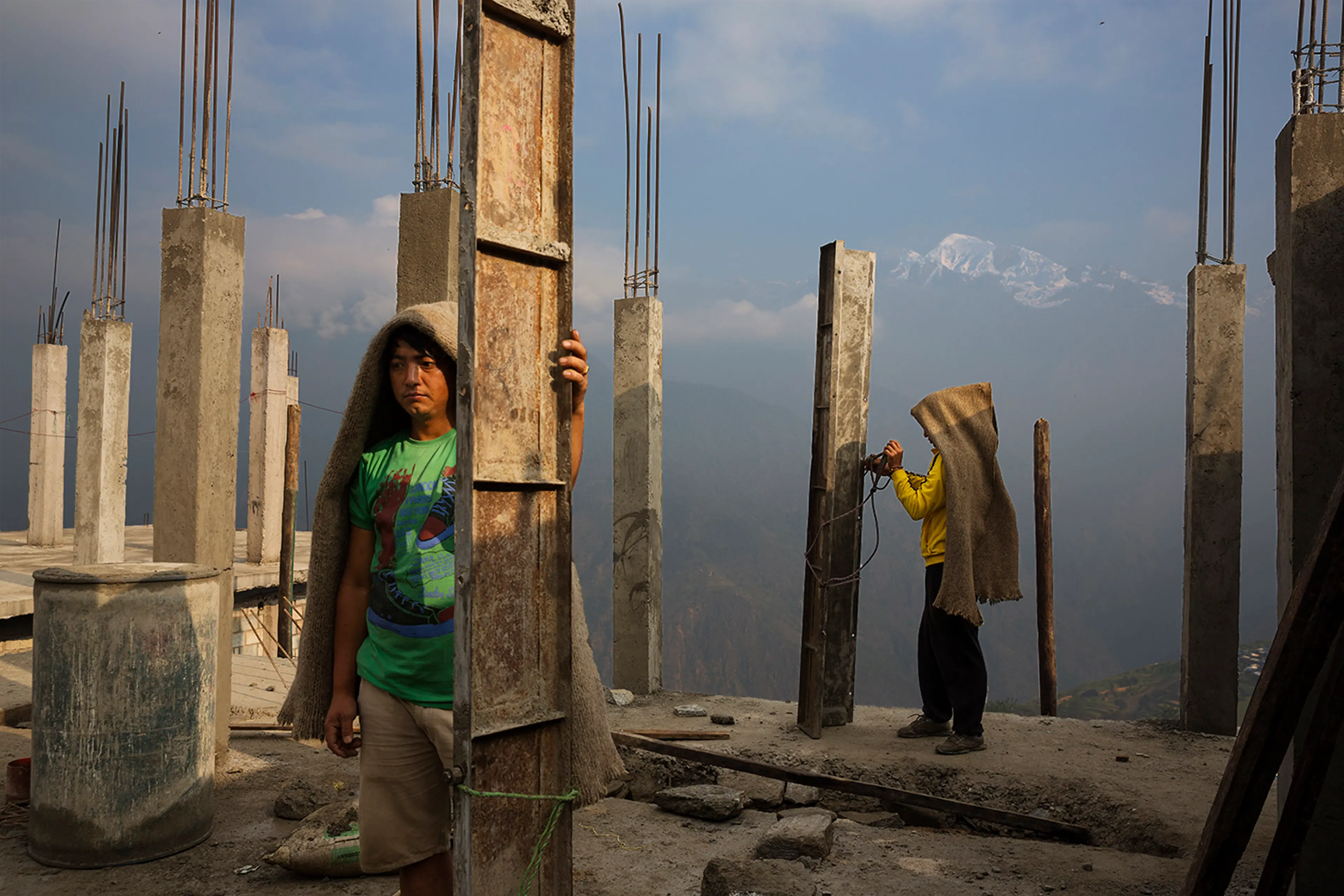 Villagers work communally to rebuild houses and a new religious stupa in the village of Barpak, in Gorkha district, Nepal at the epicenter of the 2015 quakes, which destroyed most of the village, April 5, 2016.
