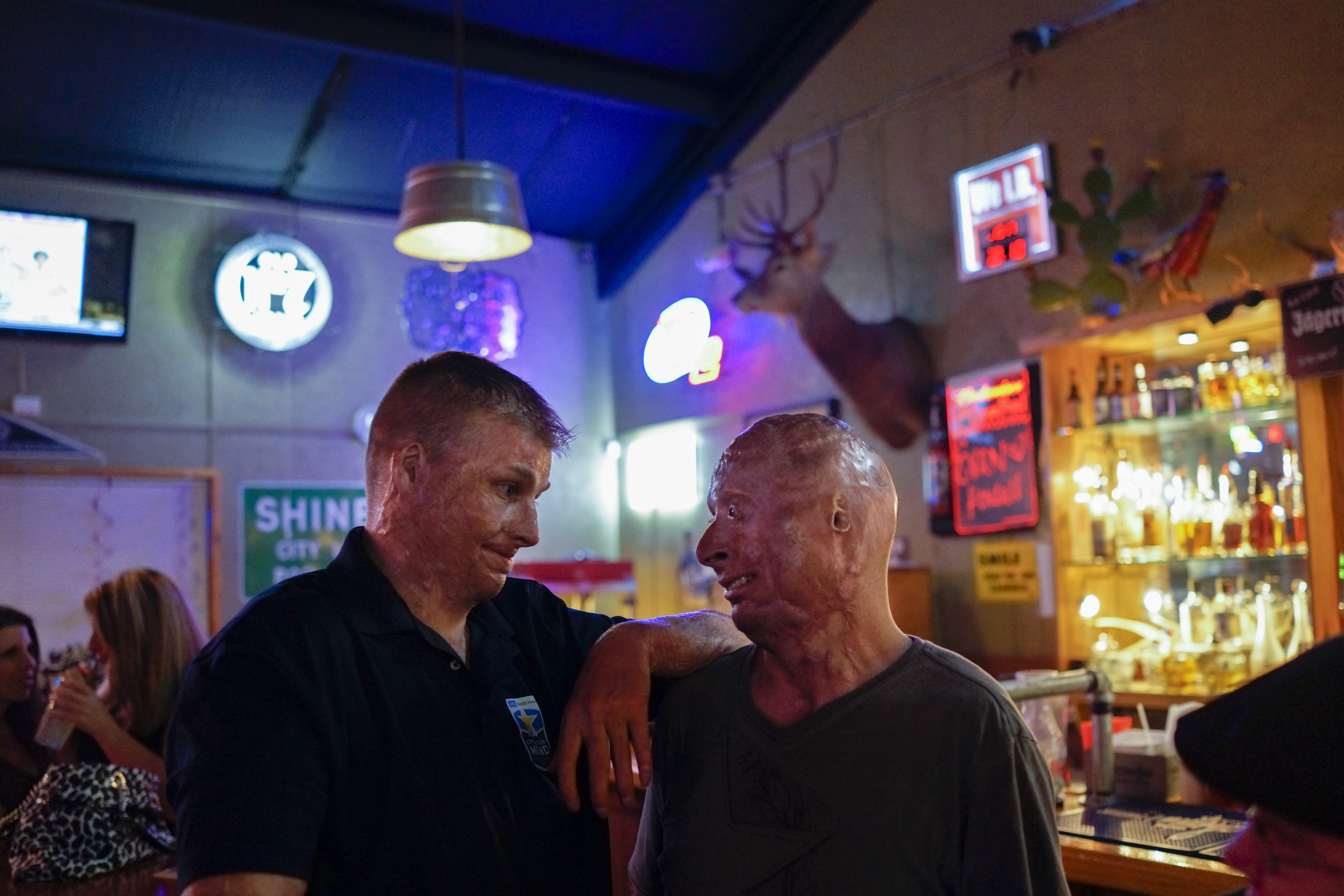2013. San Antonio, TX. USA. Bobby with a fellow burned service member at the Bracken Saloon after his weekly comedy routine. Bobby Henline, 41, veteran of four tours to Iraq and sole survivor of an IED blast that killed the other four soldiers in his hum