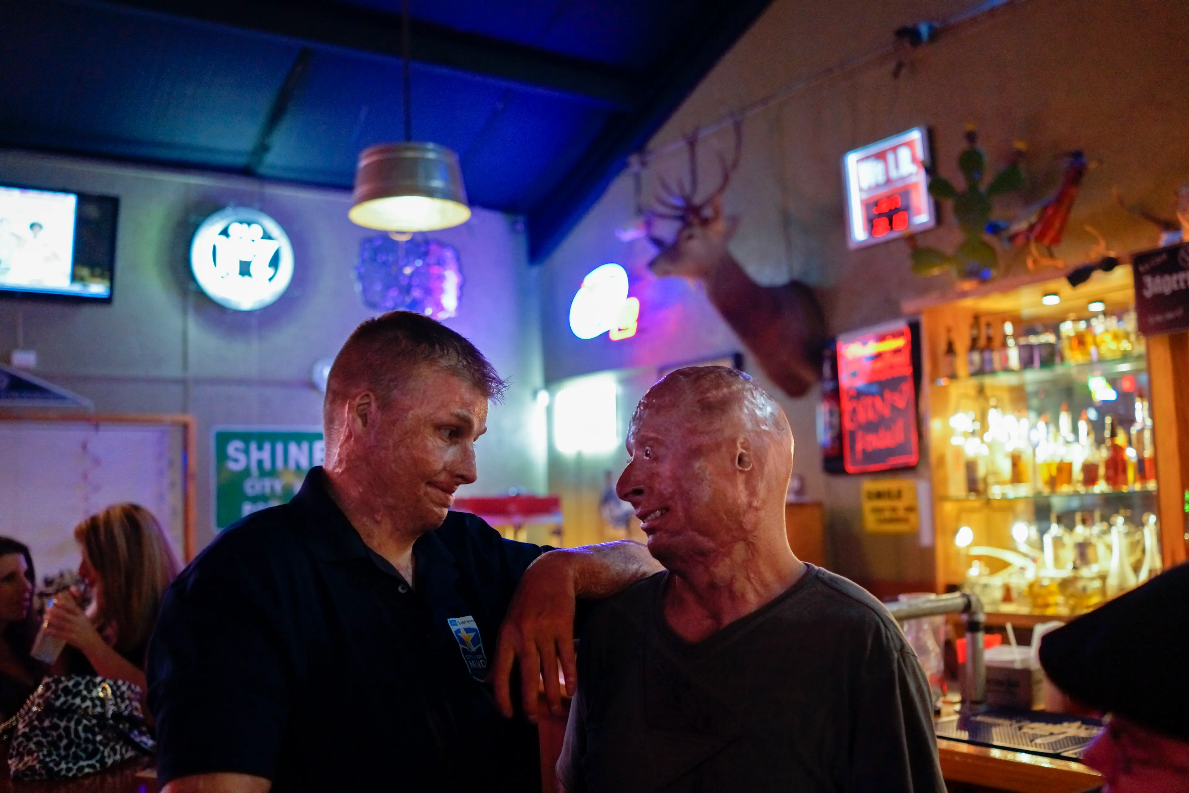 2013. San Antonio, TX. USA. Bobby with a fellow burned service member at the Bracken Saloon after his weekly comedy routine. Bobby Henline, 41, veteran of four tours to Iraq and sole survivor of an IED blast that killed the other four soldiers in his hum