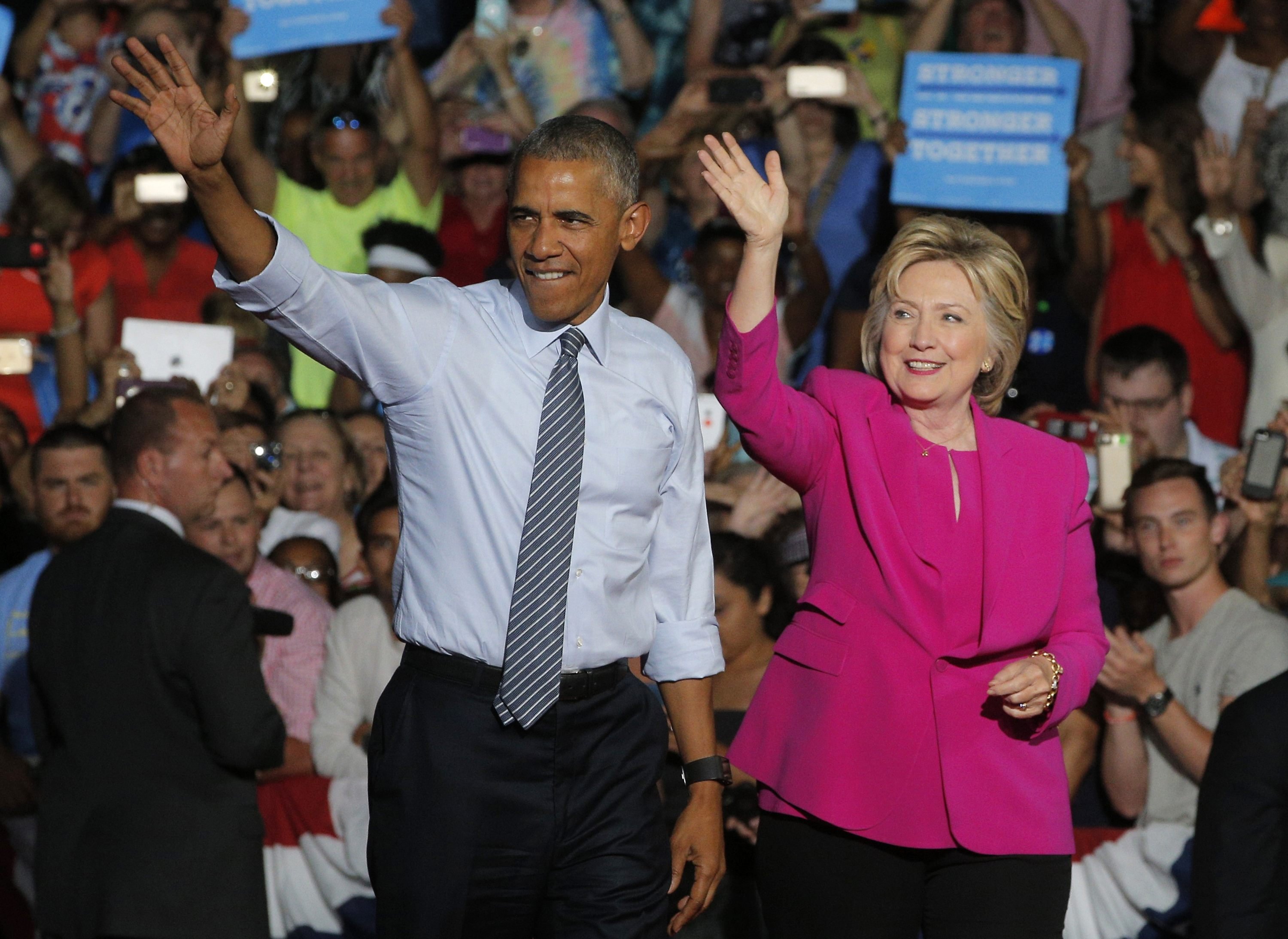 President Barack Obama waves with Democratic U.S. presidential candidate Hillary Clinton during a Clinton campaign event in Charlotte, July 5, 2016.