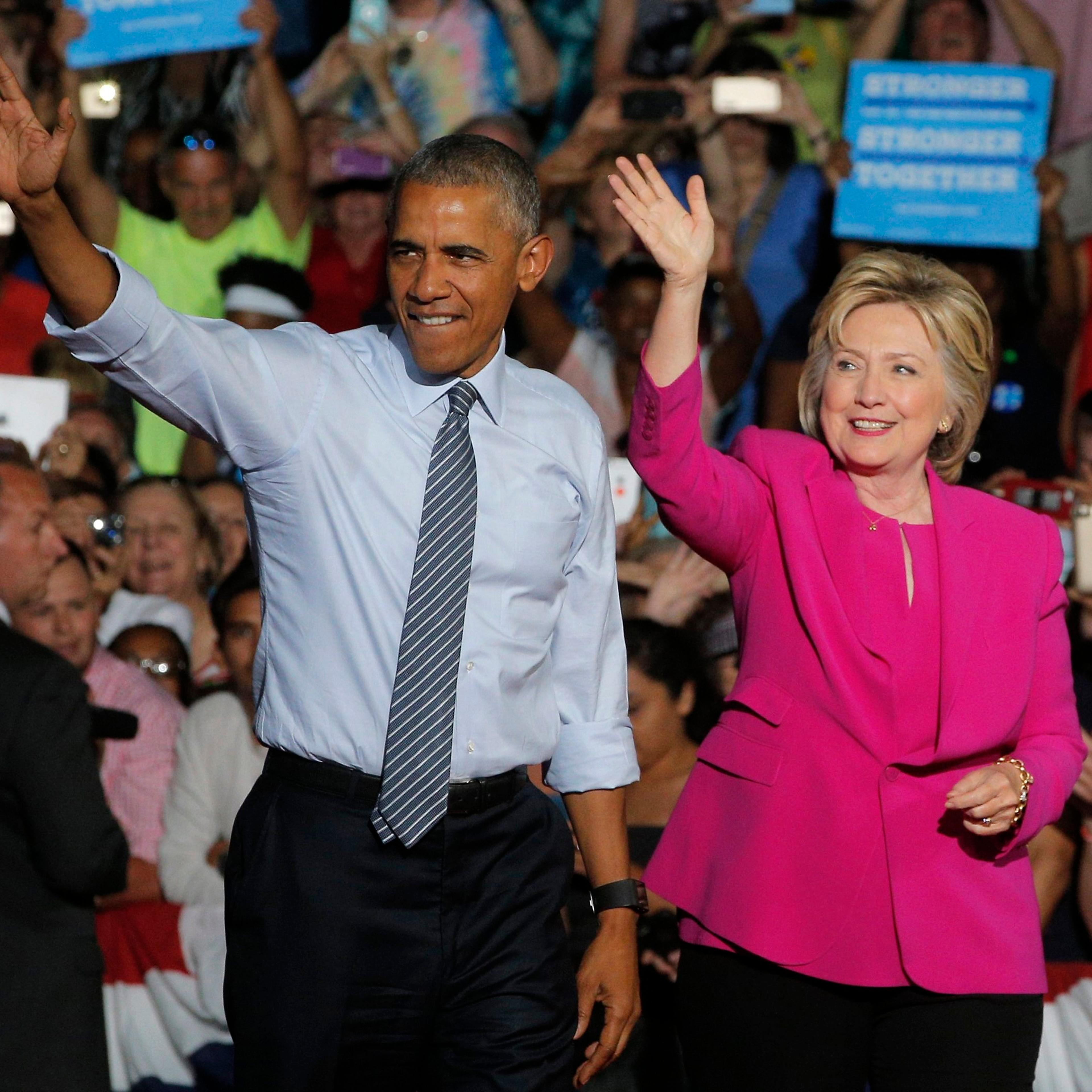 President Barack Obama waves with Democratic U.S. presidential candidate Hillary Clinton during a Clinton campaign event in Charlotte, July 5, 2016.