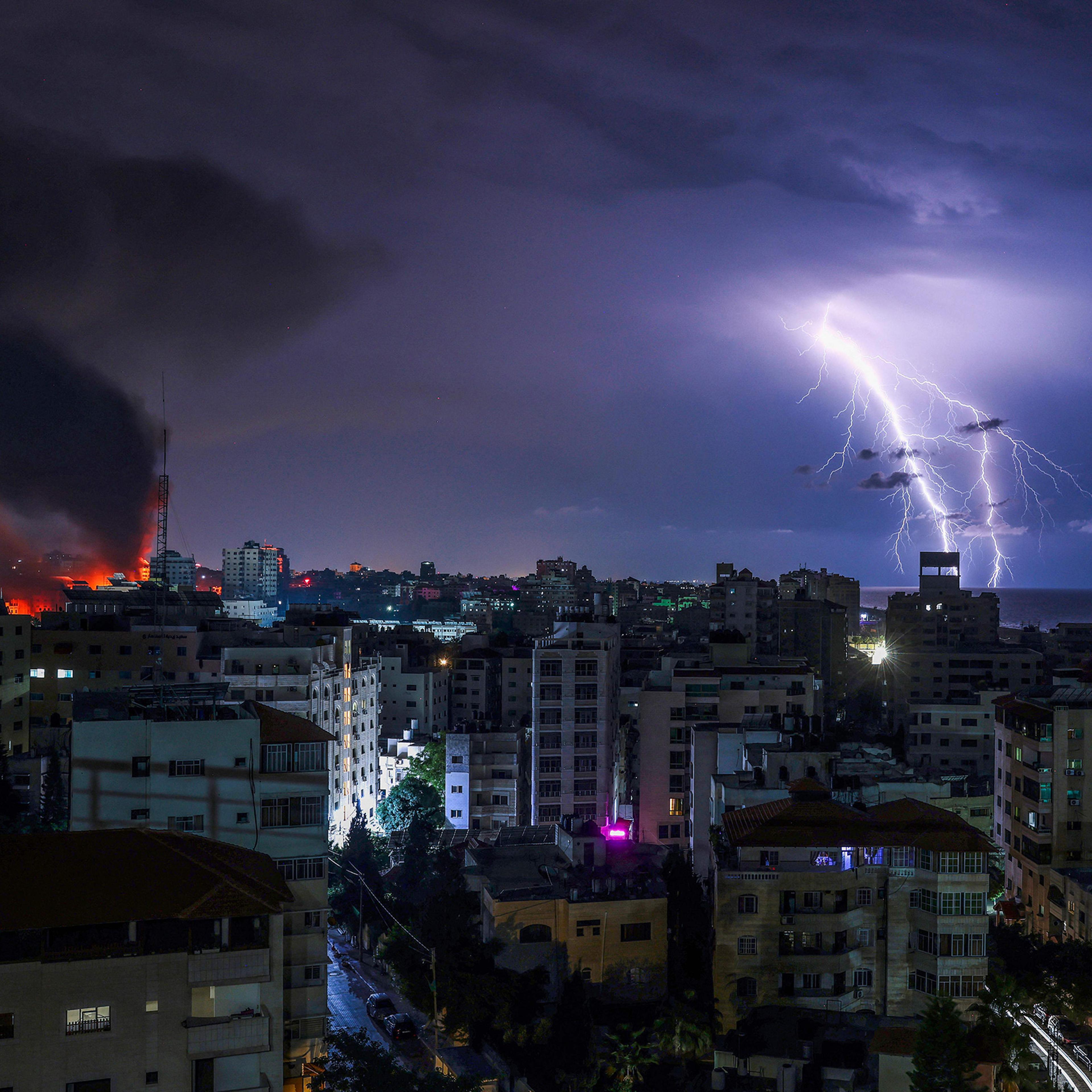 Lightning strikes as smoke billows following an Israeli airstrike in Gaza City on Oct. 9.