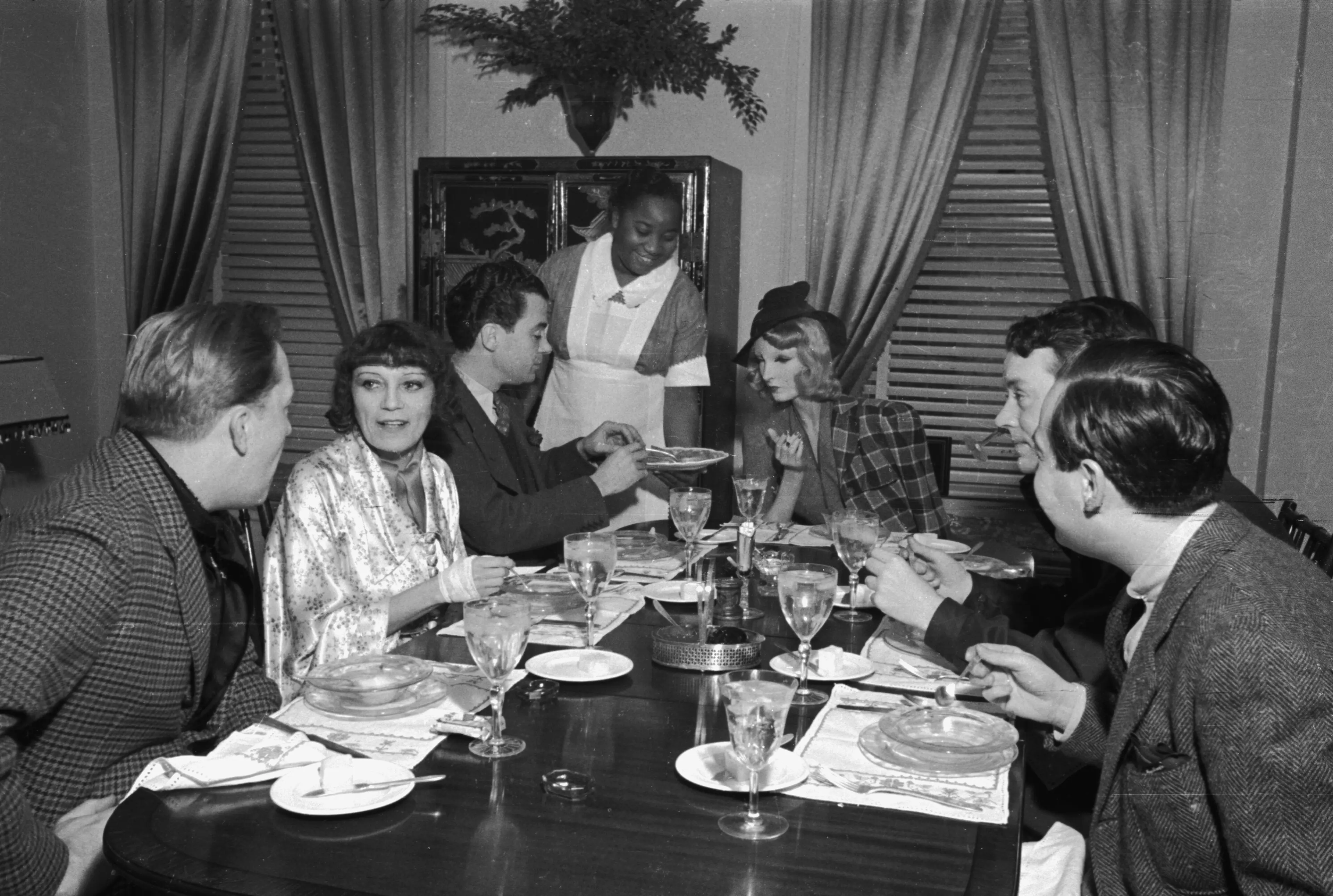Sunday brunch at novelist Thyra Samter Winslow's Park Avenue home in 1937. Cynthia the mannequin sits to the right of mural painter Franklin Hughes.
