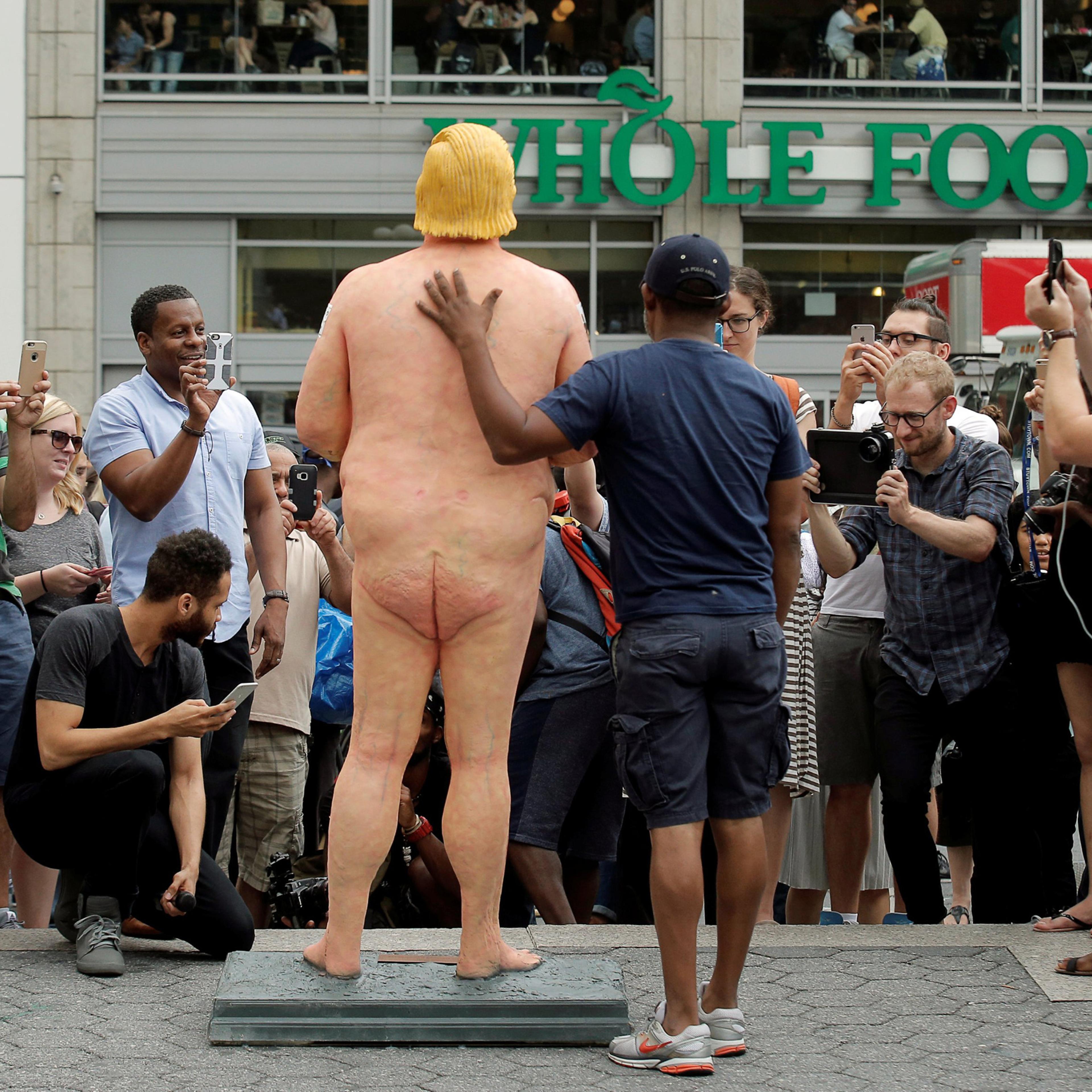People photograph a naked statue of Republican U.S. presidential nominee Donald Trump that was left in Union Square Park in New York City on Aug. 18, 2016.
