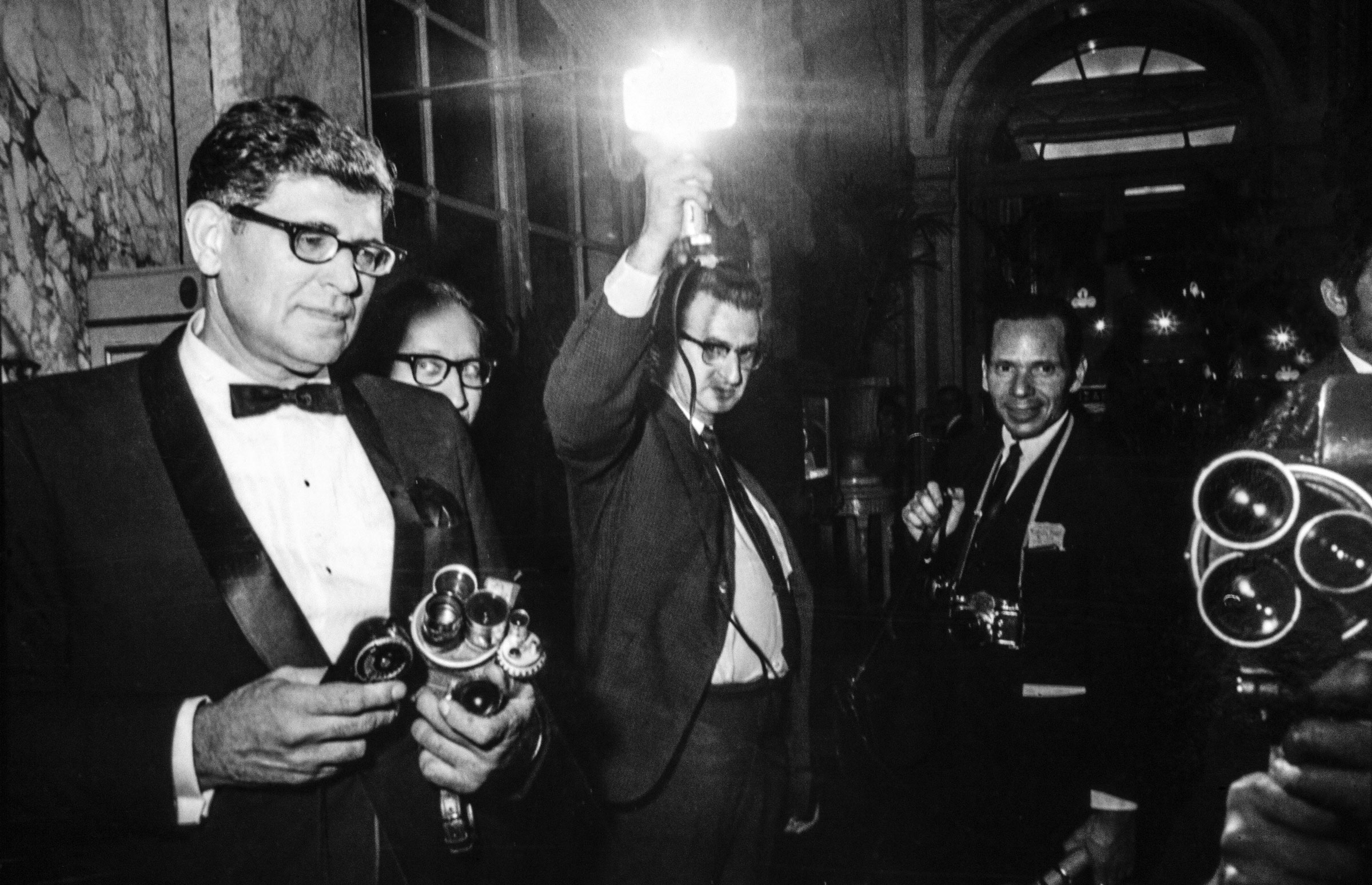 The press take photographs at the Black and White Ball at the Plaza Hotel.