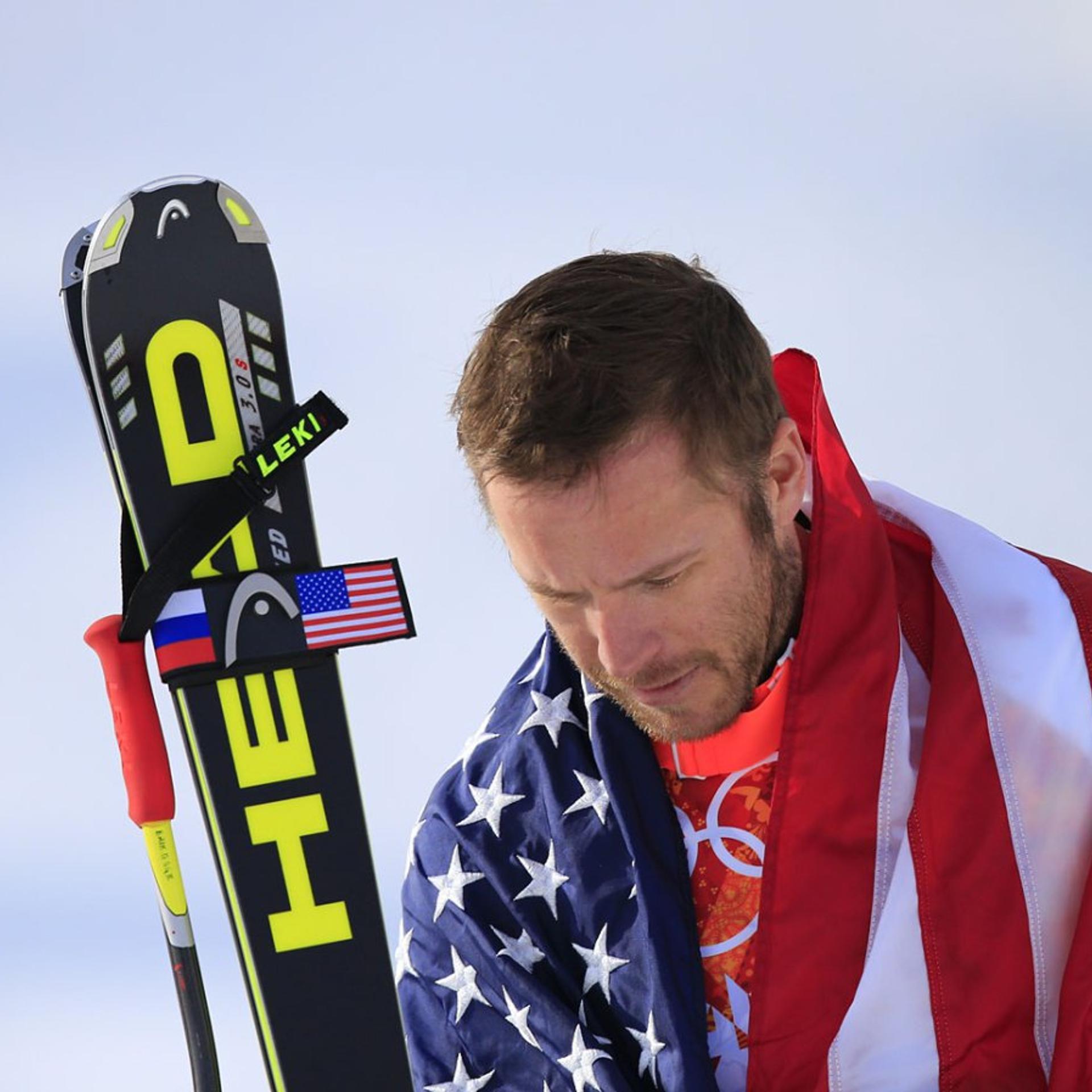 Bode Miller arrives on the podium during the Men's Alpine Skiing Super-G Flower Ceremony.