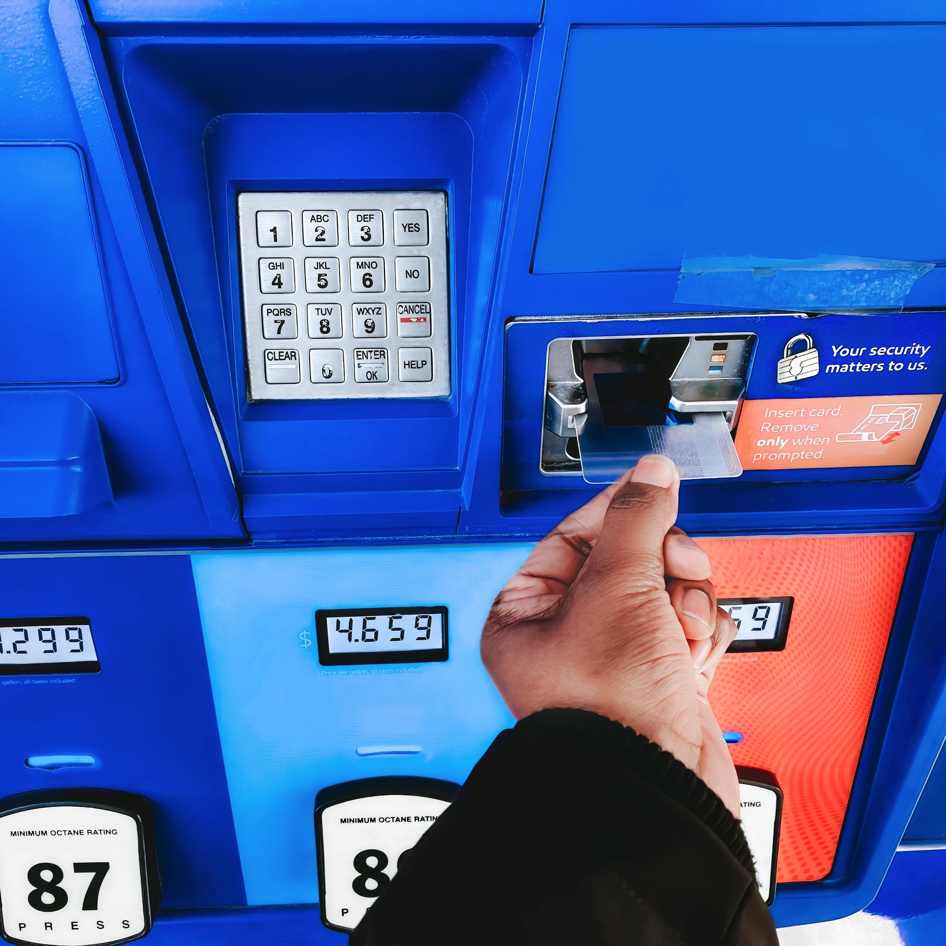 Woman Purchases Gas at Pump