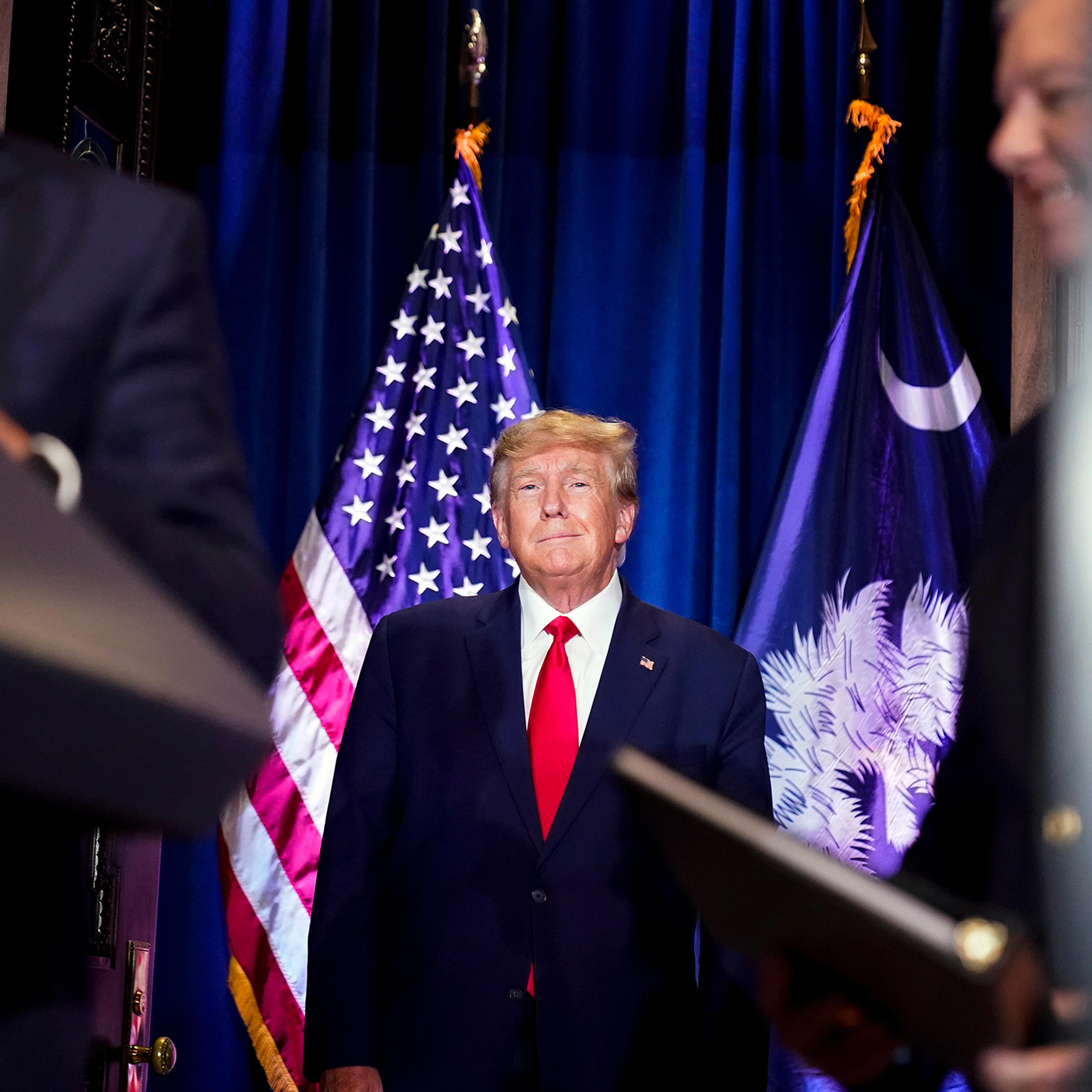 Former President Donald Trump arrives to speak at a campaign event at the South Carolina Statehouse on Jan. 28, in Columbia, S.C. Sen. Lindsey Graham, R-S.C., is at right.