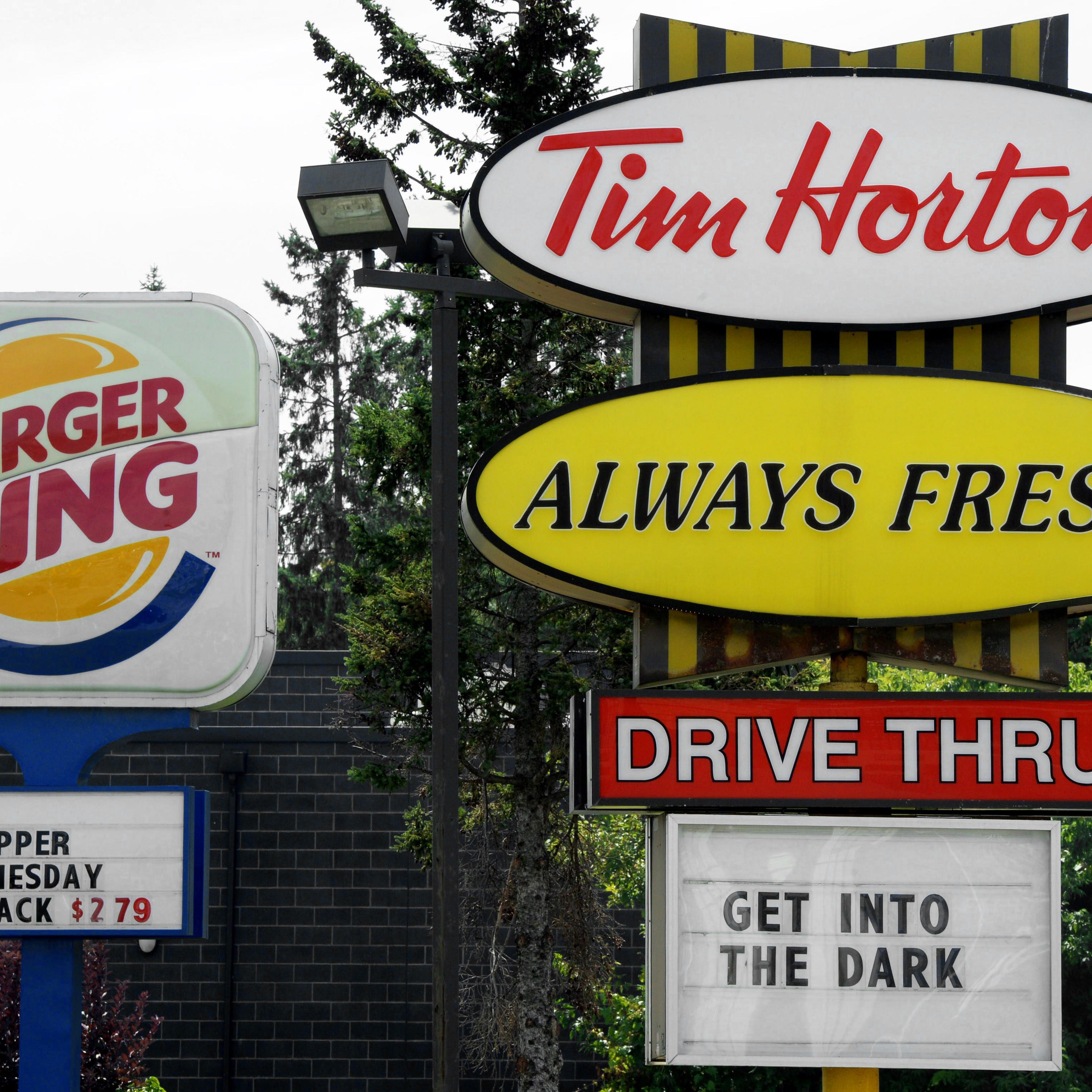 A Burger King sign and a Tim Hortons sign are displayed on St. Laurent Boulevard in Ottawa, Canada on Aug. 25, 2014.