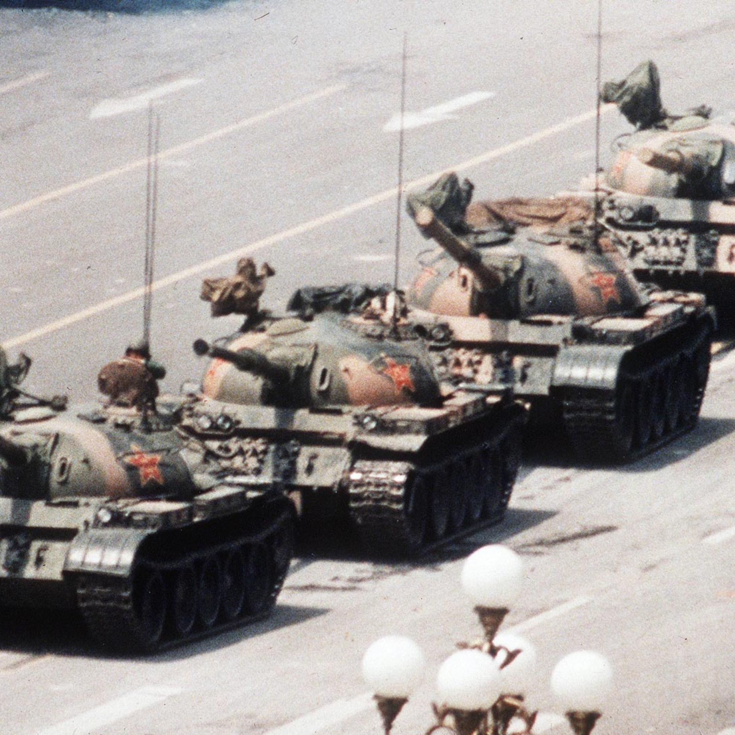A Chinese man stands alone to block a line of tanks heading east on Beijing's Changan Avenue in Tiananmen Square on June 5, 1989. The man, calling for an end to the recent violence and bloodshed against pro-democracy demonstrators, was pulled away by bystanders, and the tanks continued on their way.