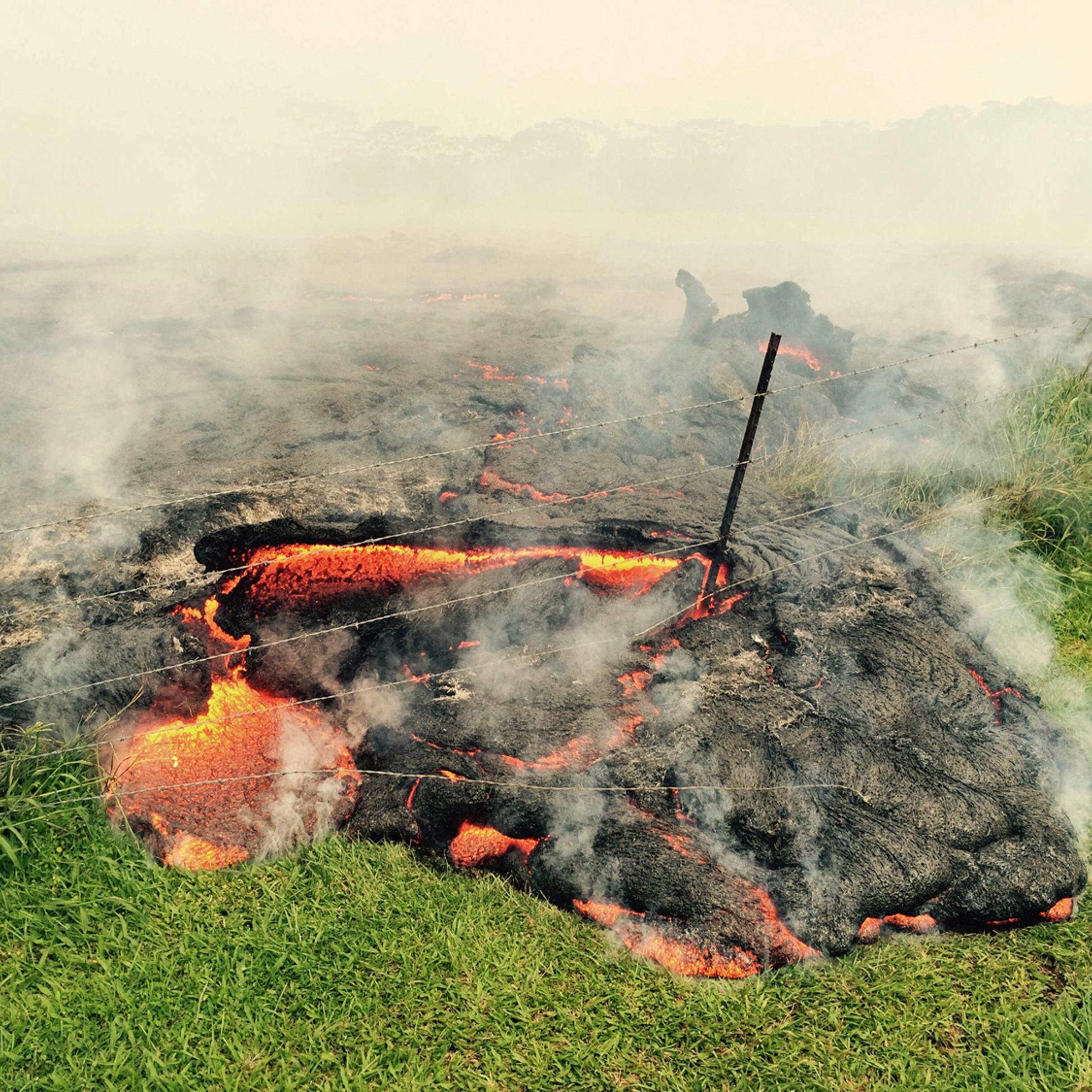 The lava flow from the Kilauea Volcano is seen advancing across a pasture near the village of Pahoa, Hawaii