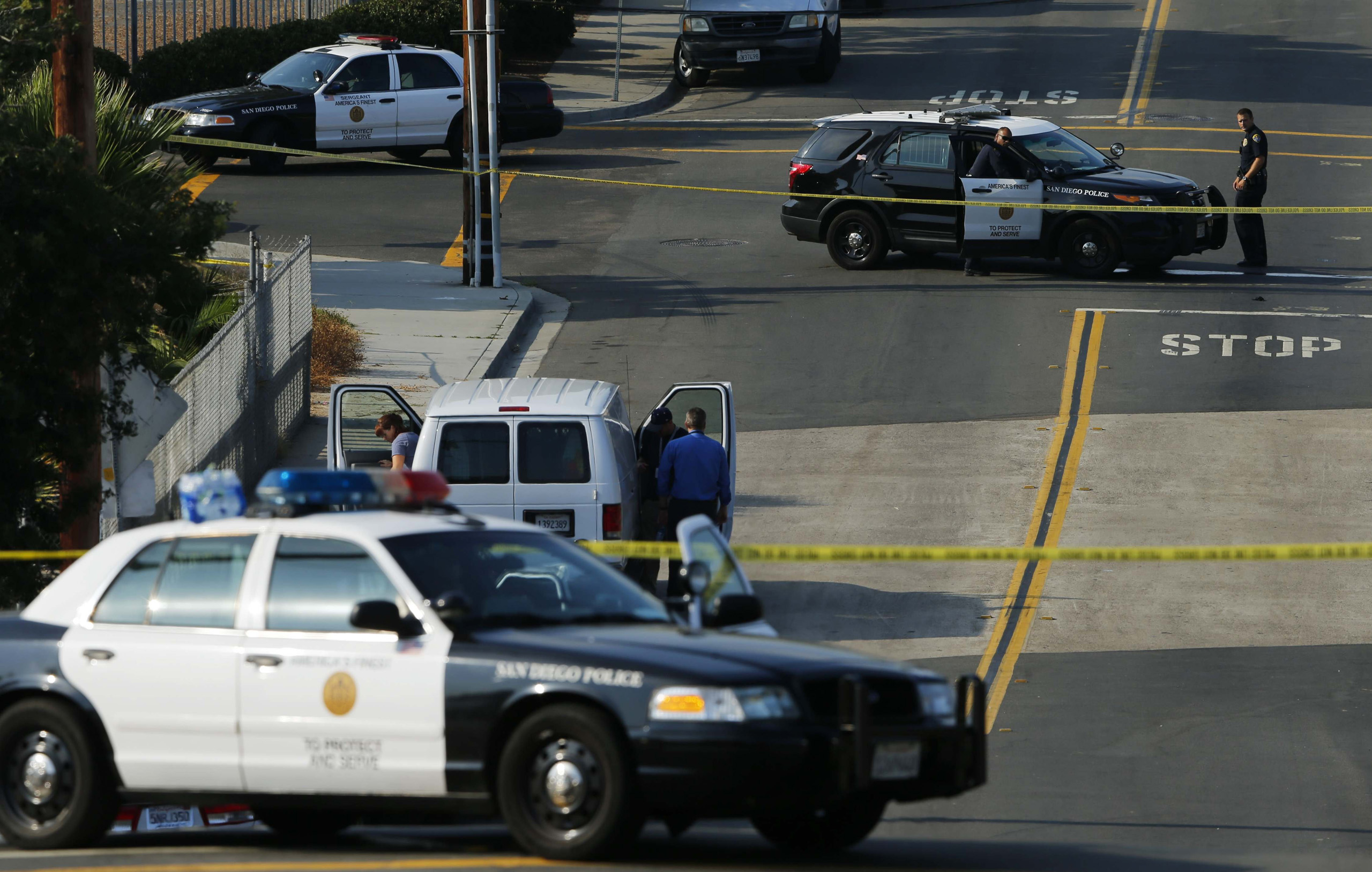 Police investigators arrive near the scene where an officer was fatally shot and another was injured at a traffic stop late in San Diego on July 29, 2016.
