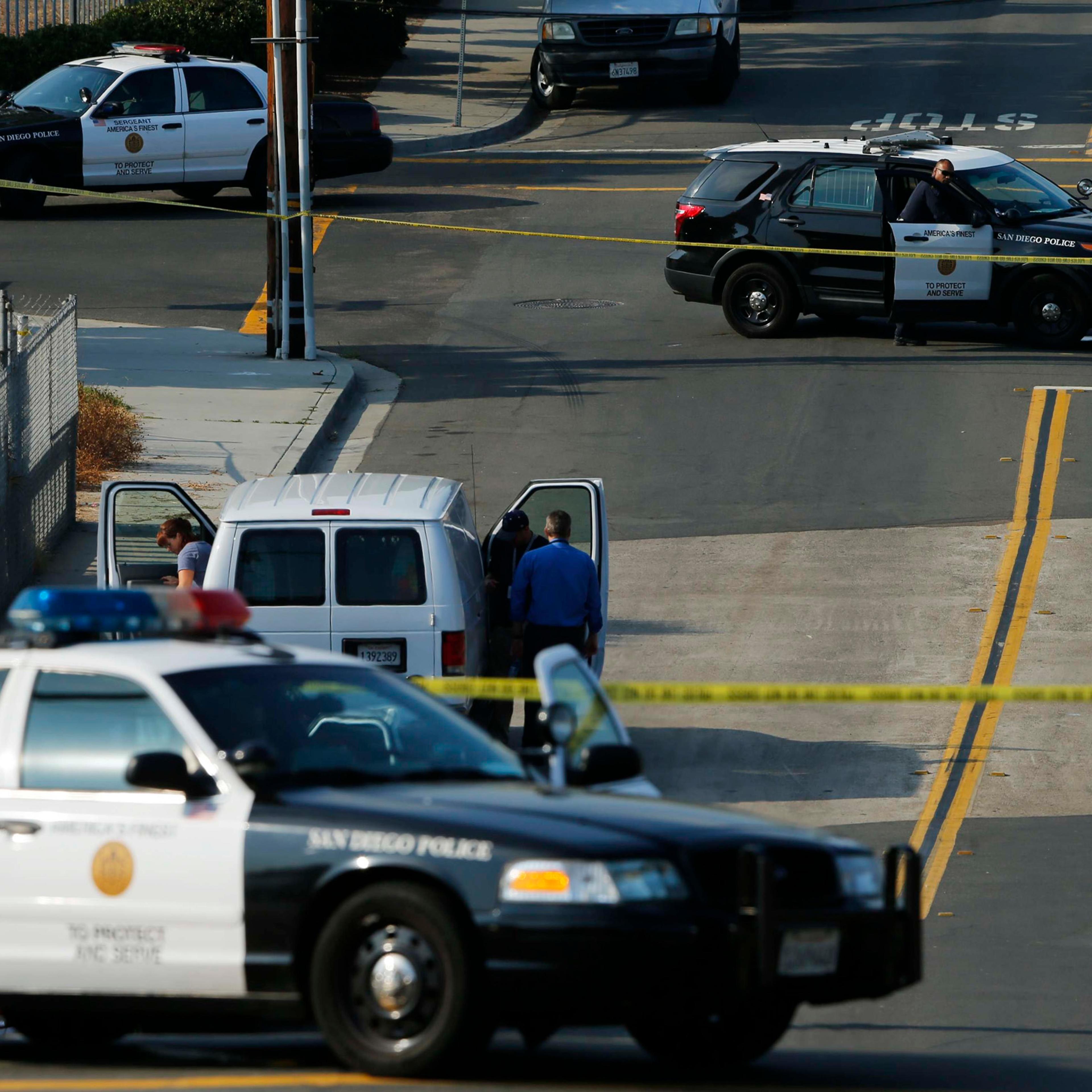 Police investigators arrive near the scene where an officer was fatally shot and another was injured at a traffic stop late in San Diego on July 29, 2016.