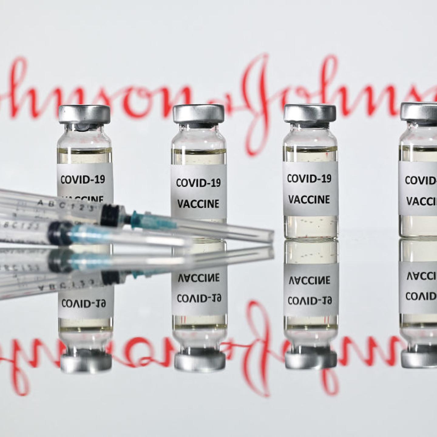 An illustration picture shows vials with COVID-19 vaccine stickers attached and syringes with the logo of U.S. pharmaceutical company Johnson & Johnson on November 17, 2020.