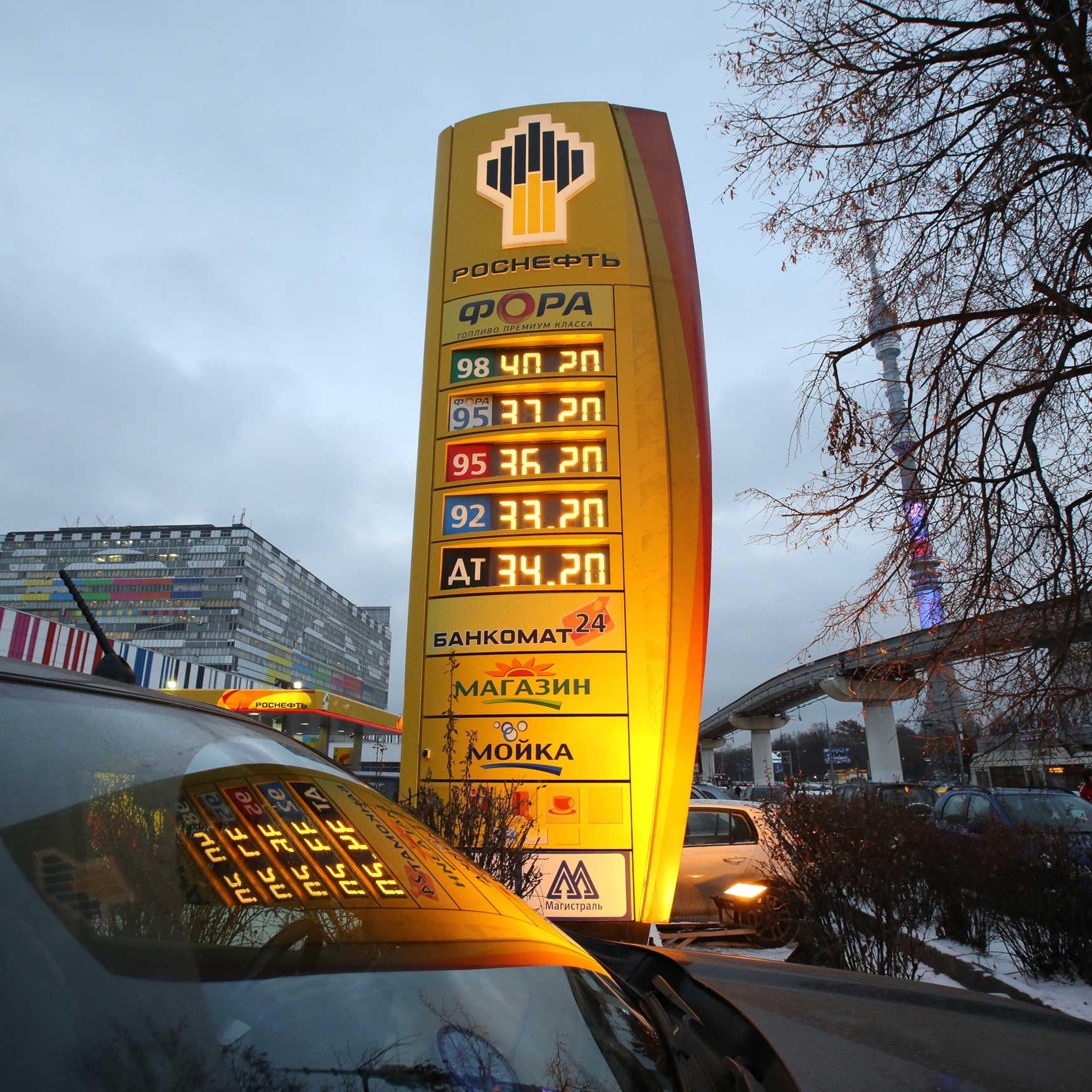 Ruble fuel prices sit on an illuminated electronic display board outside an OAO Rosneft gas station in Moscow, Dec. 2, 2014.