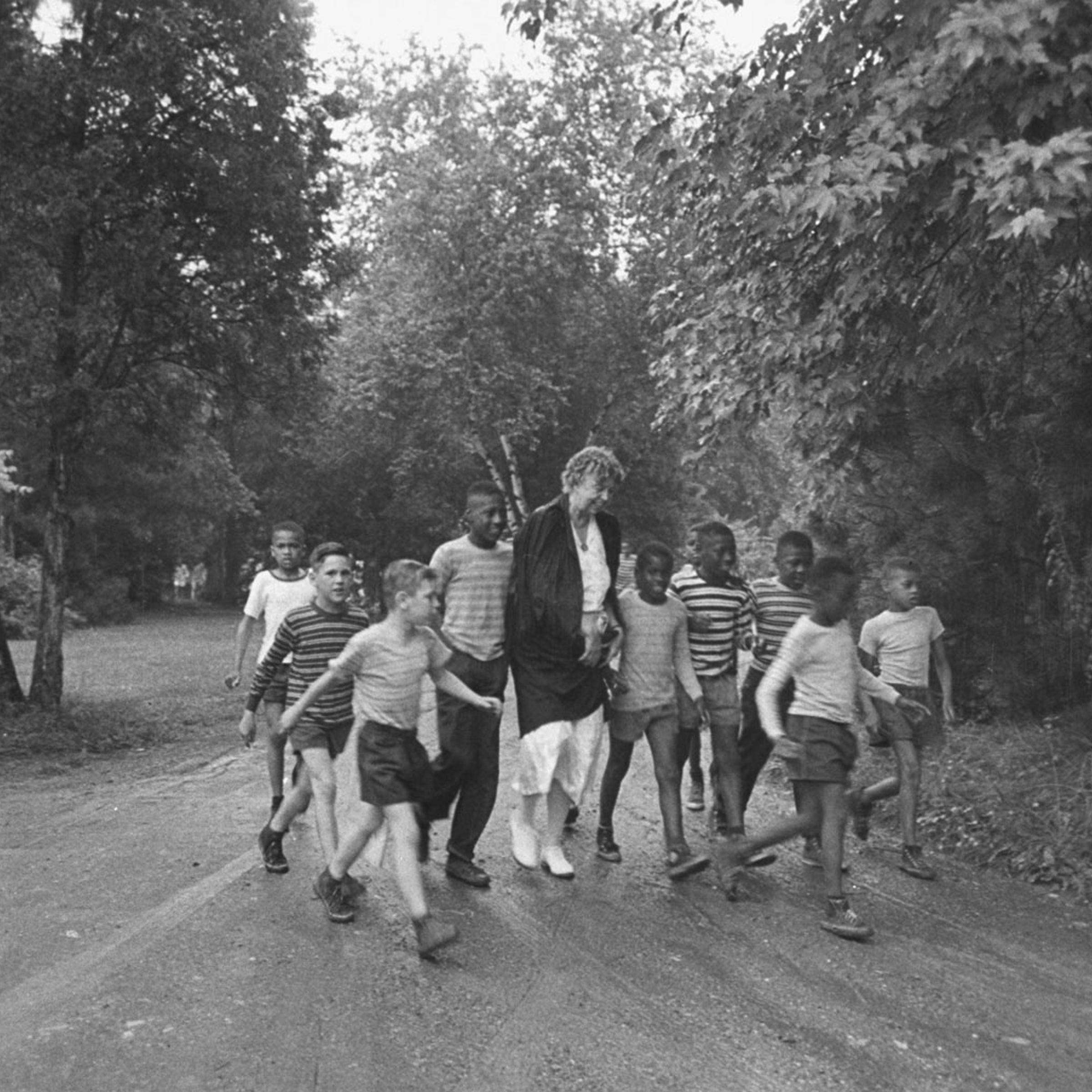 Former First Lady Eleanor Roosevelt walks with children en route to a picnic, 1948.