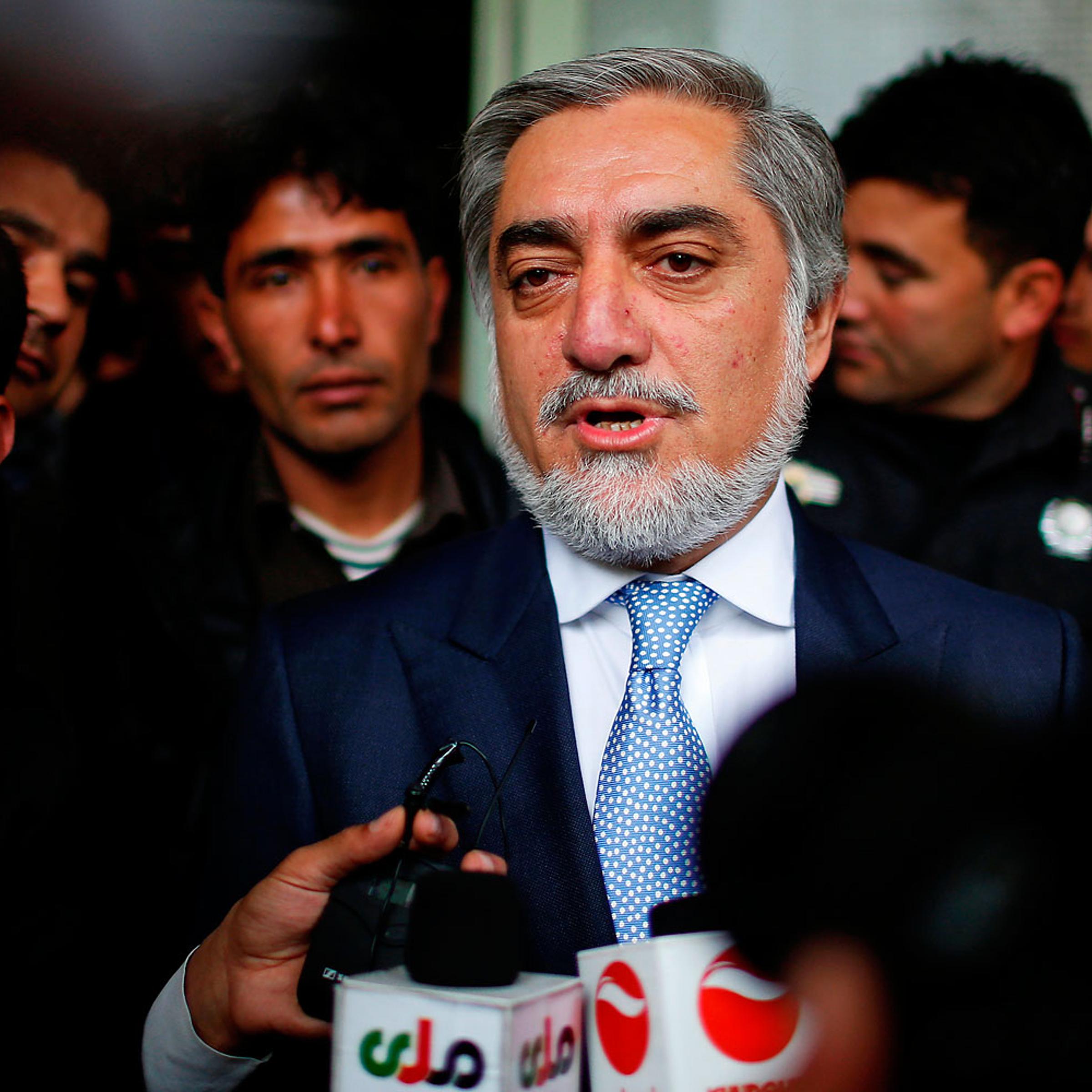 Afghan presidential candidate Abdullah Abdullah speaks to the media after voting at a polling station in Kabul