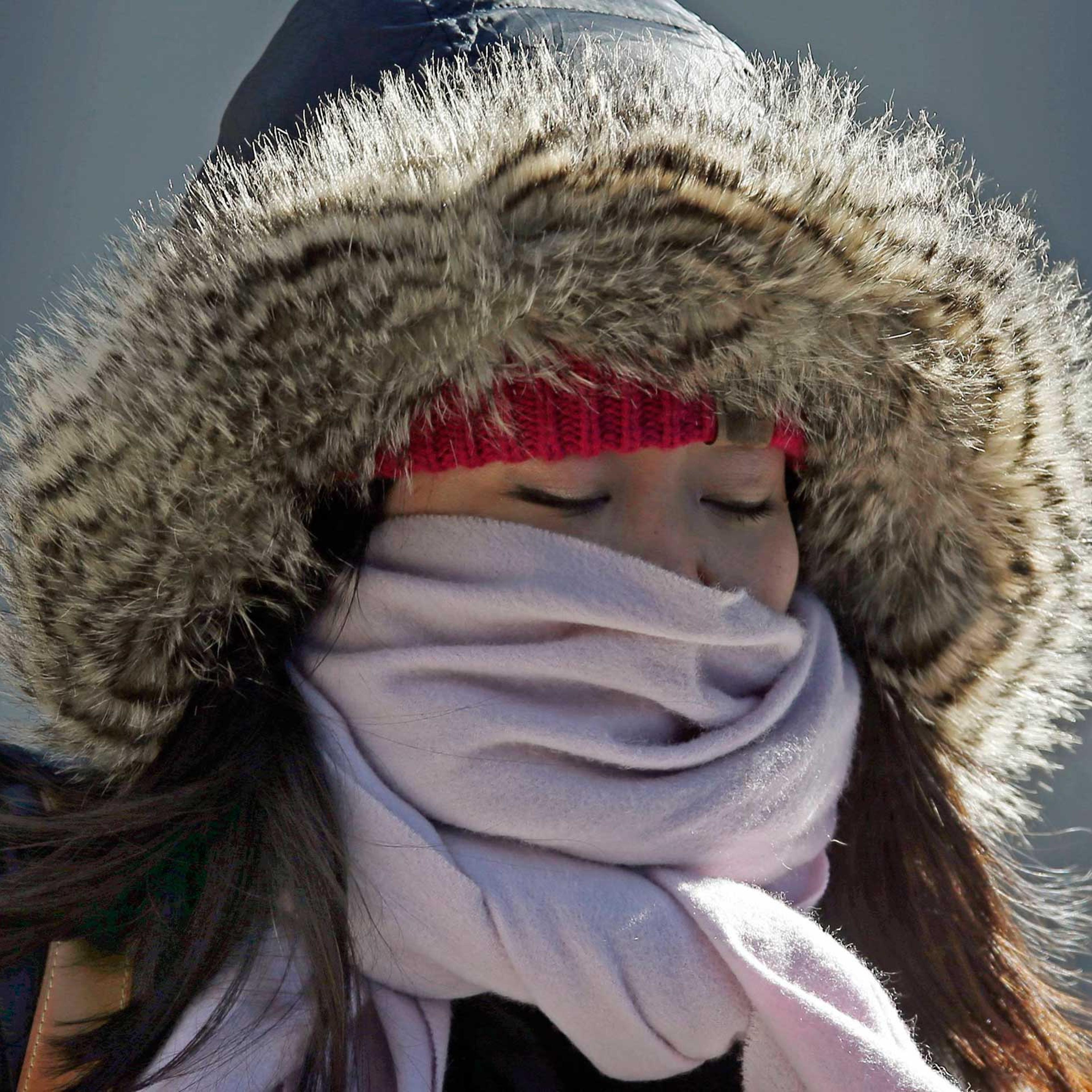 A woman walks through downtown Chicago