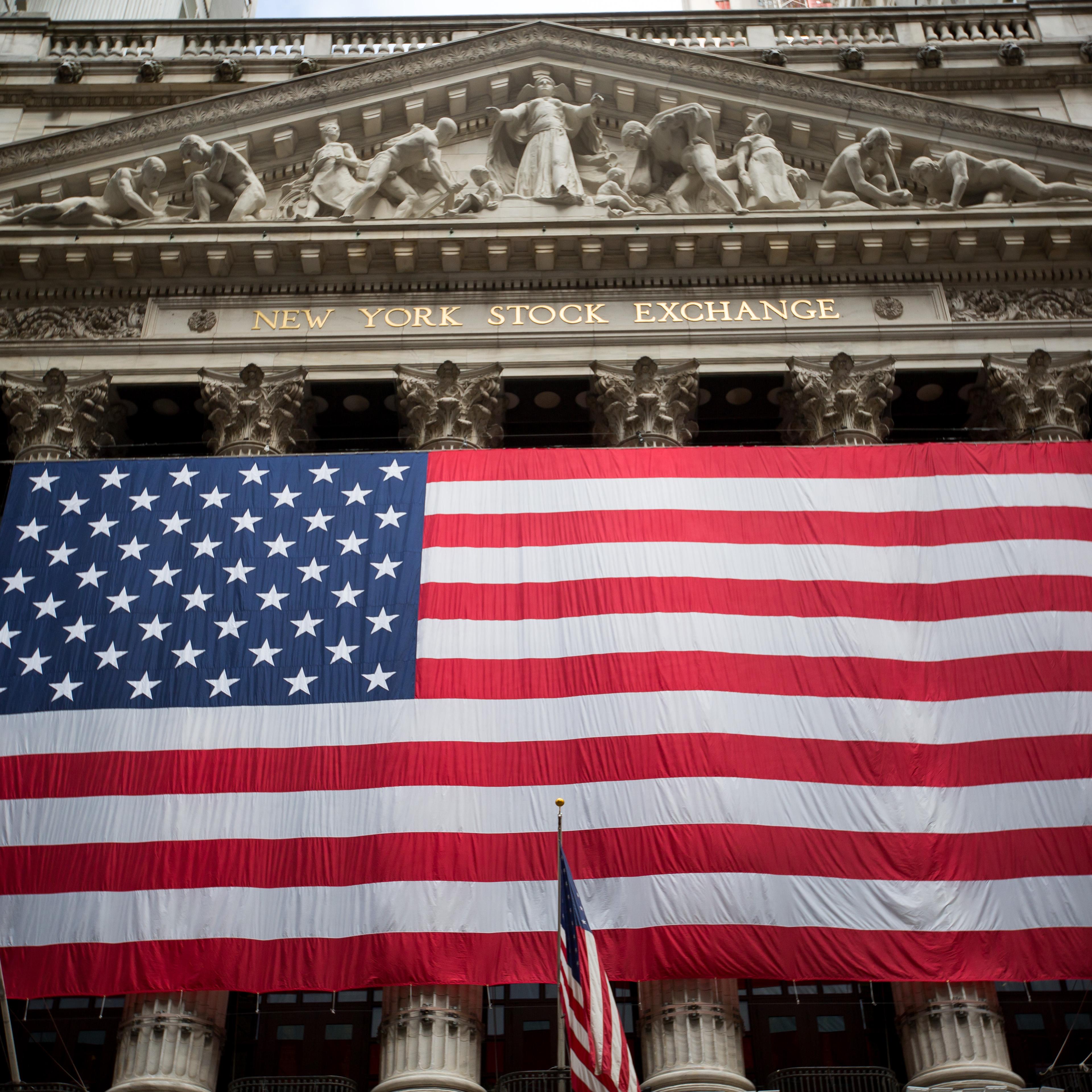 An American flag is displayed outside the New York Stock Exchange (NYSE) stands in New York, U.S., on Tuesday, July 5, 2016.