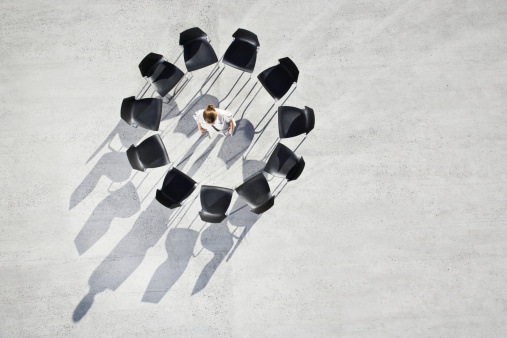 businesswoman-standing-empty-chairs