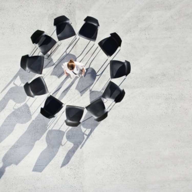 businesswoman-standing-empty-chairs