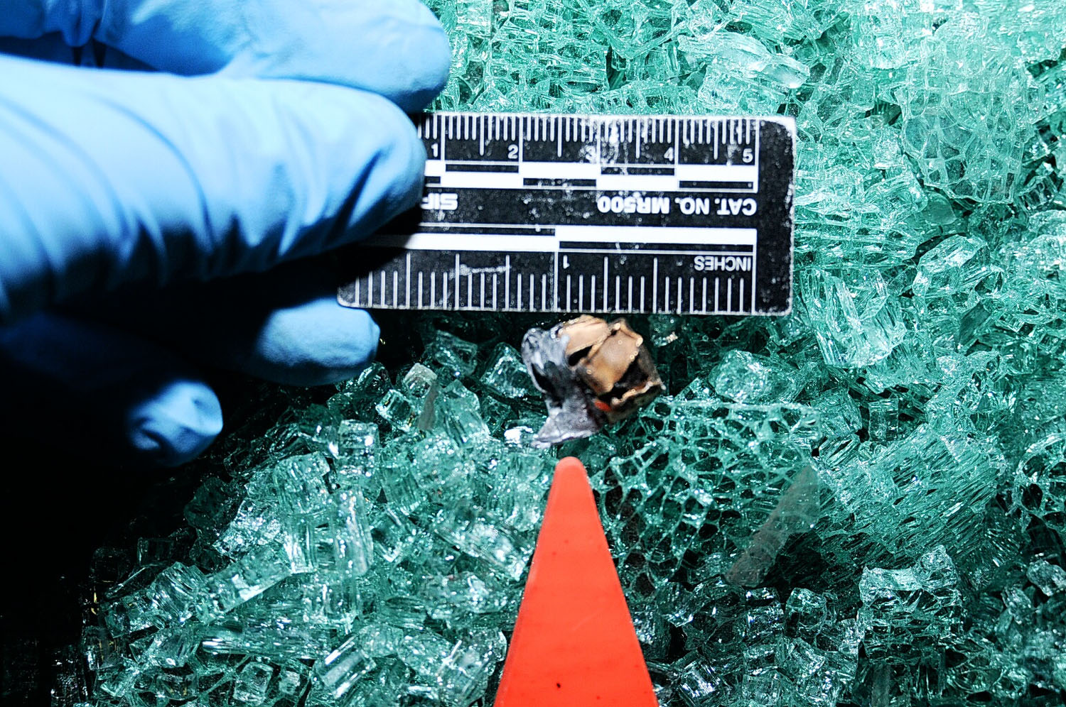 An undated evidence photograph made available by the St. Louis County prosecutors office on Nov. 25, 2014 shows glass and a slug taken from Ferguson police officer Darren Wilson's vehicle after the shooting of Michael Brown.