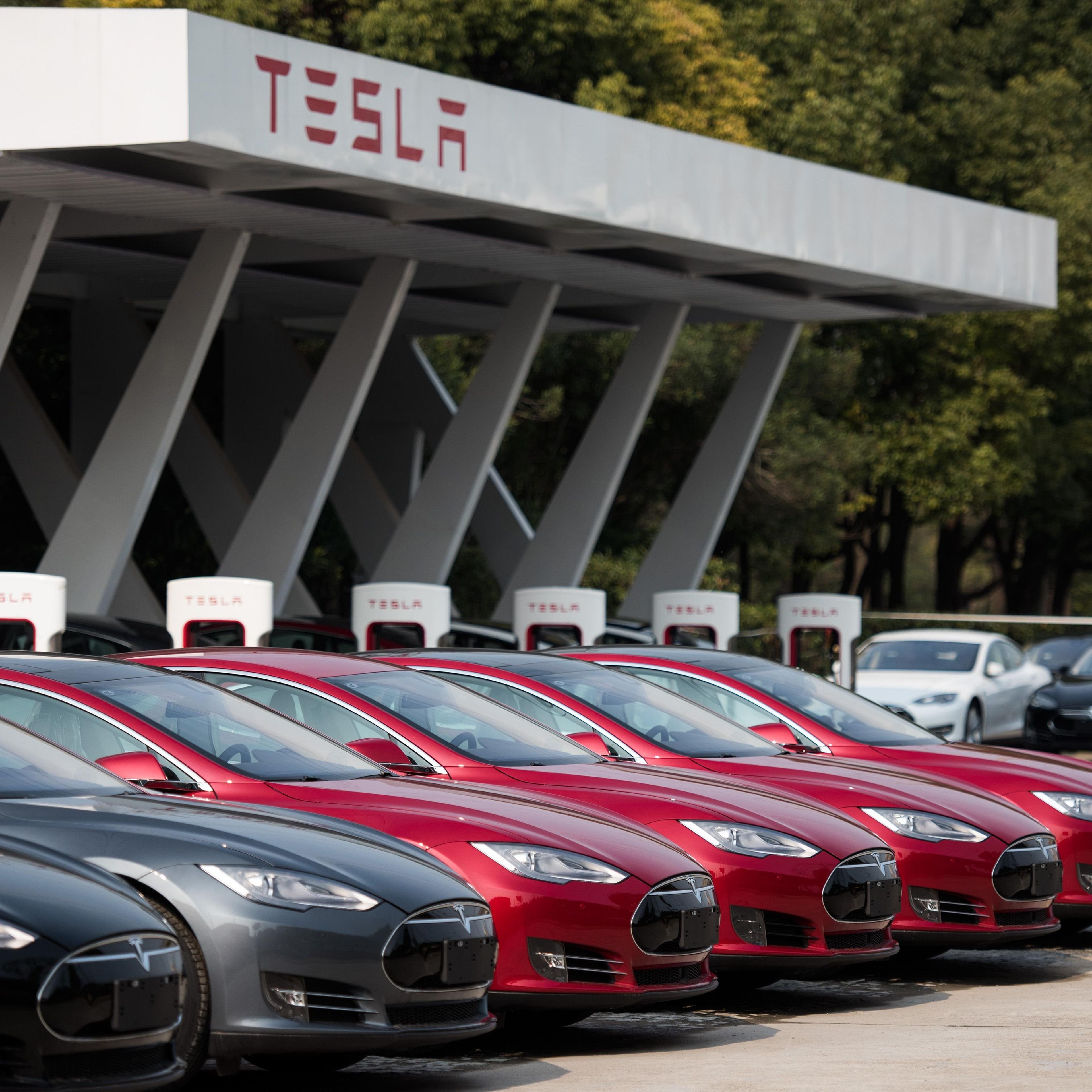 Tesla Model S vehicles parked outside a car dealership in Shanghai on March 17, 2015.