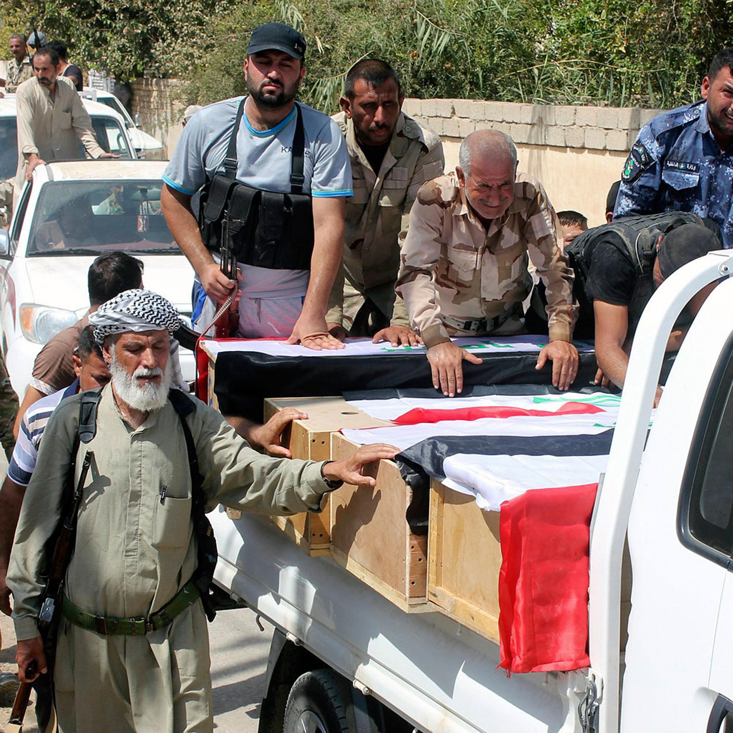Mourners carry the coffins of Iraqi Shi'ite volunteers, who were killed during clashes with militants of the Islamic State in Amerli. during a funeral in Khalis