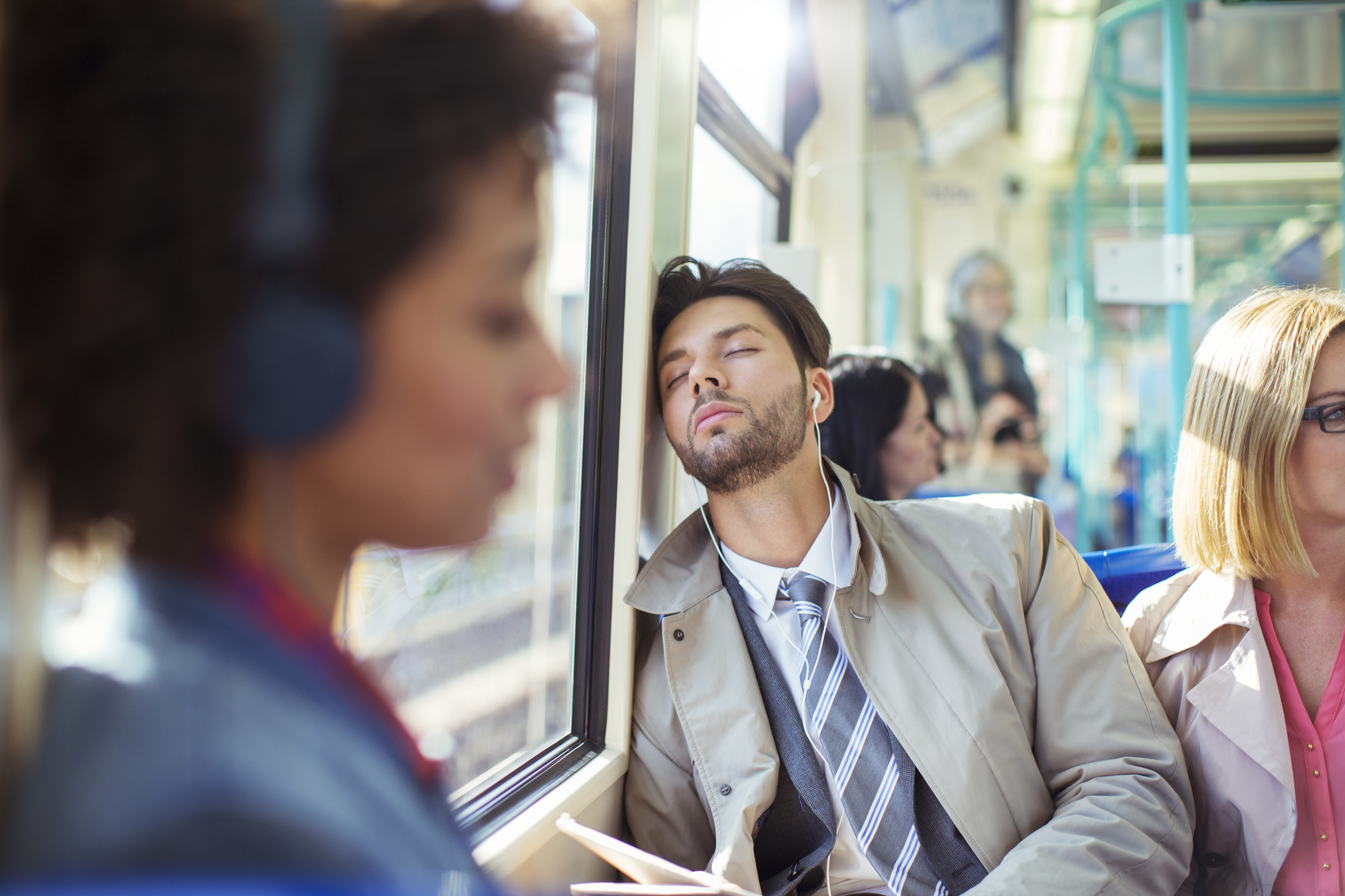 Businessman napping on train