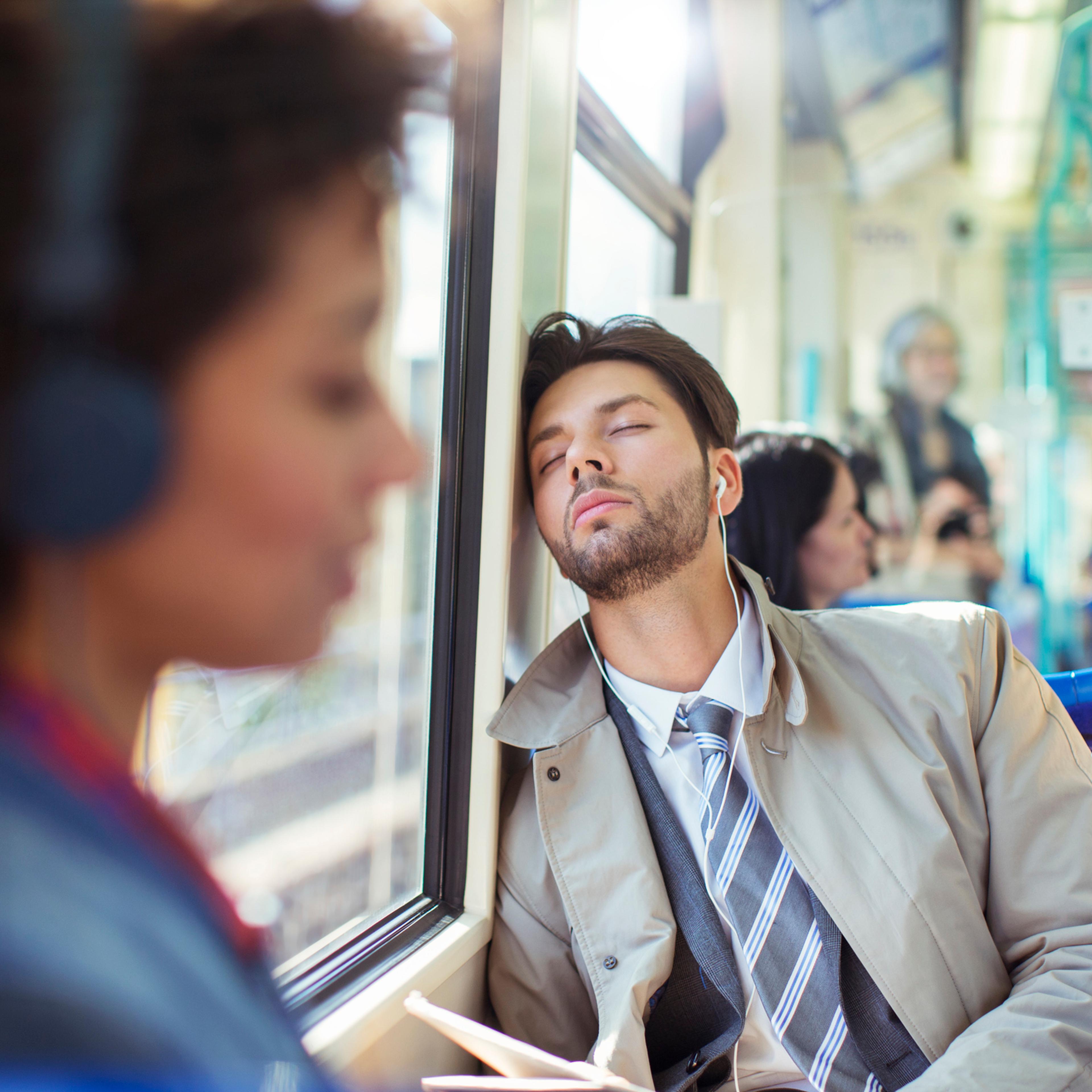 Businessman napping on train