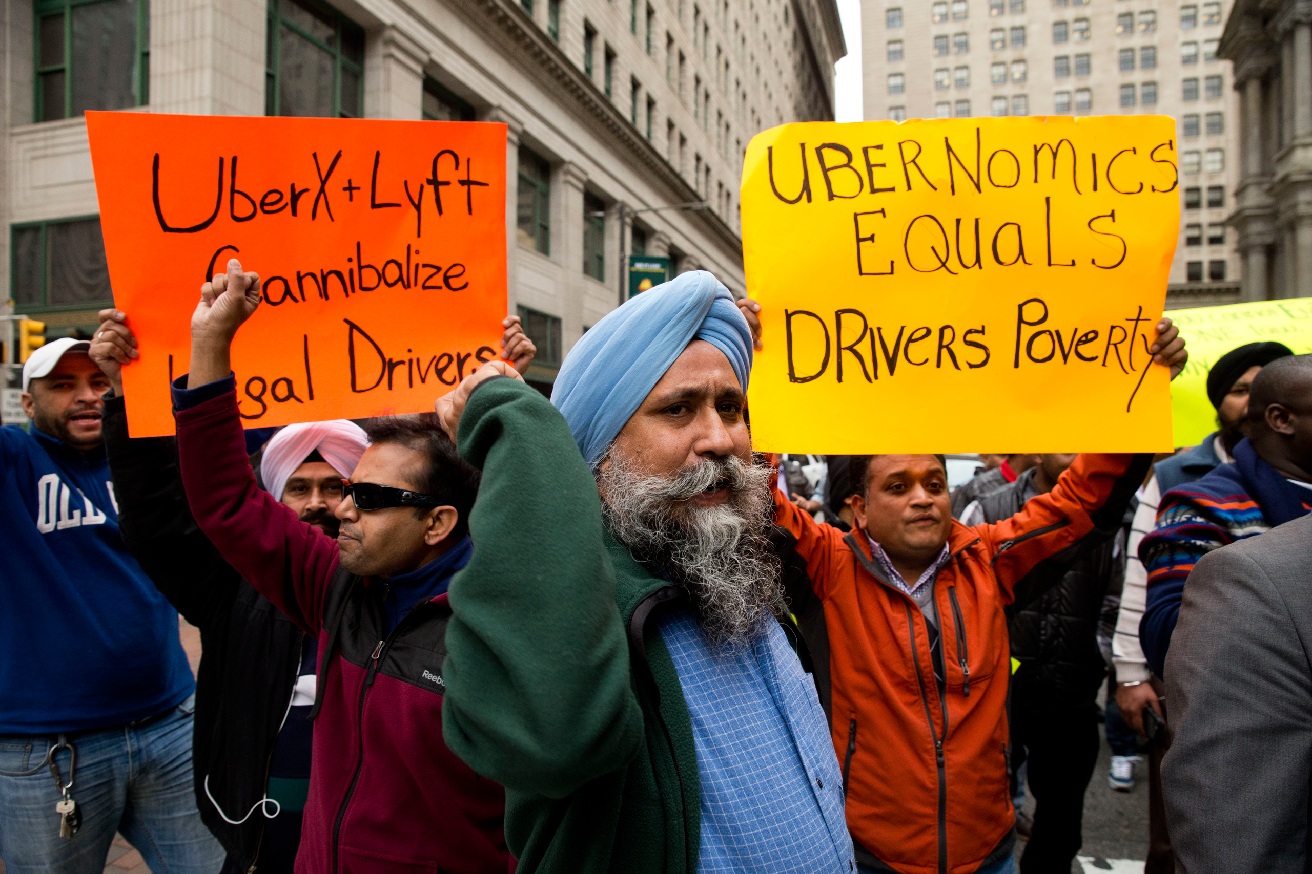 Taxi and Uber's black car service drivers protest the ride-hailing services Uber X and Lyft Wednesday, Dec. 16, 2015, in Philadelphia. The drivers are protesting that Uber and Lyft are operating without legal approval in the city. Uber says it understand