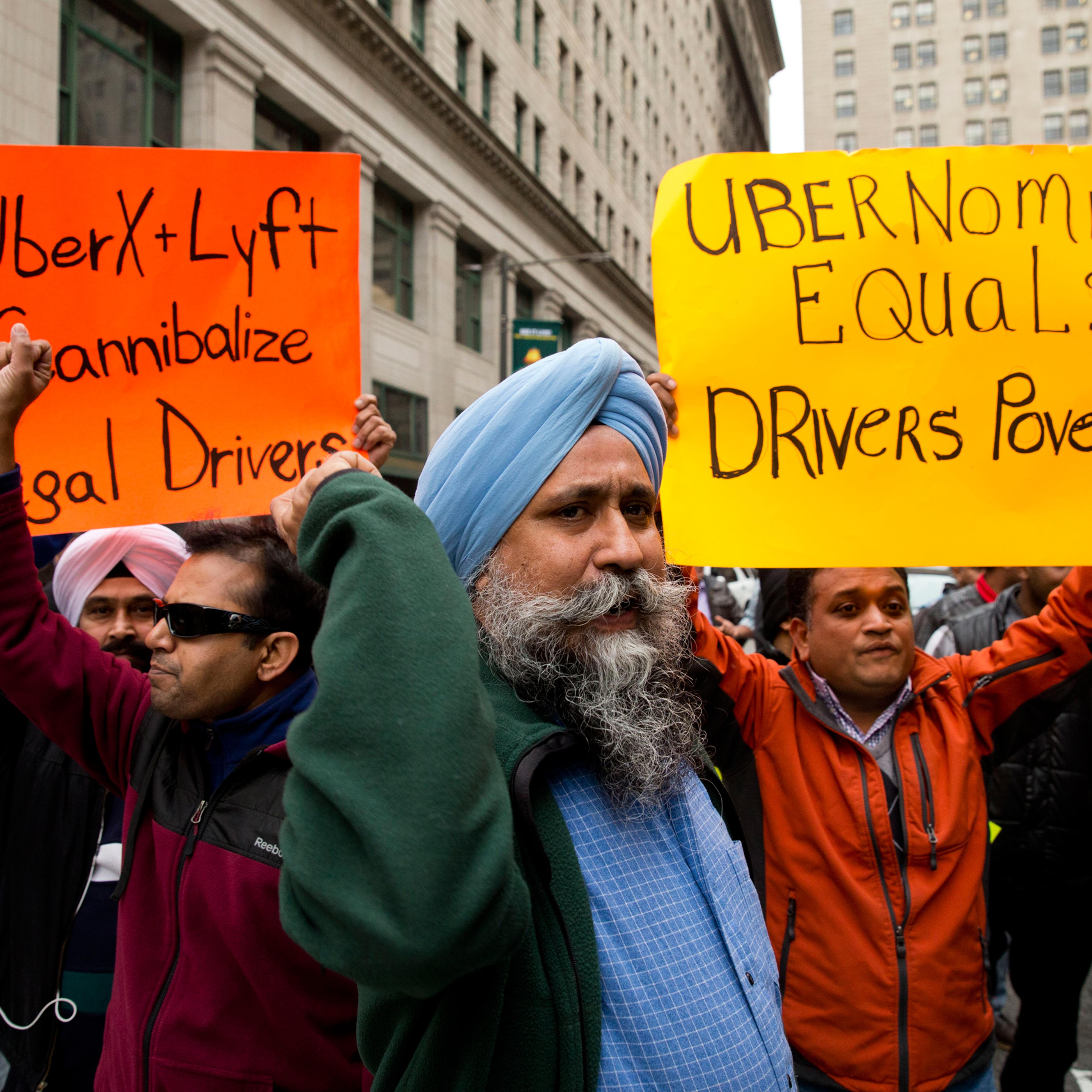 Taxi and Uber's black car service drivers protest the ride-hailing services Uber X and Lyft Wednesday, Dec. 16, 2015, in Philadelphia. The drivers are protesting that Uber and Lyft are operating without legal approval in the city. Uber says it understand