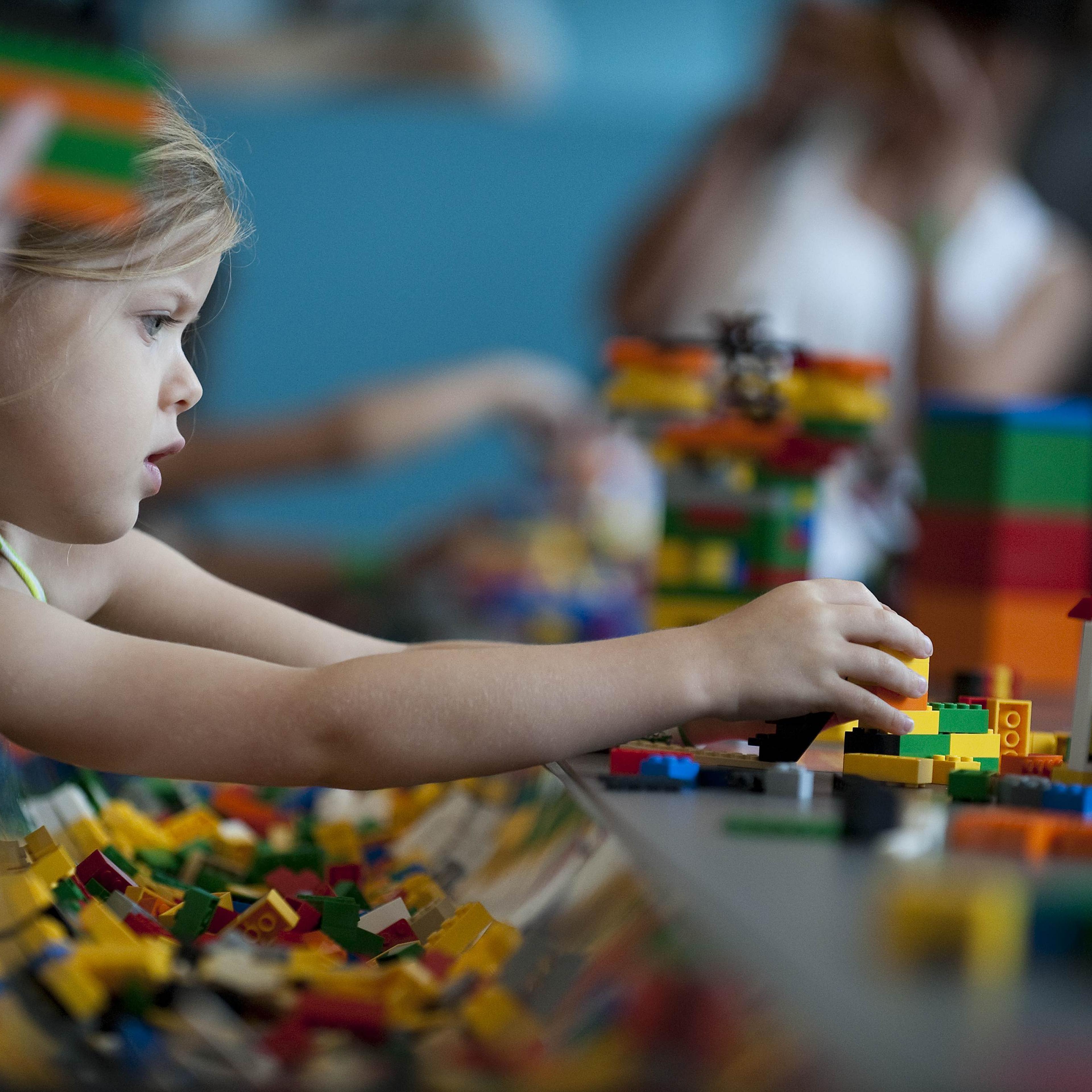 A child plays with Lego building blocks