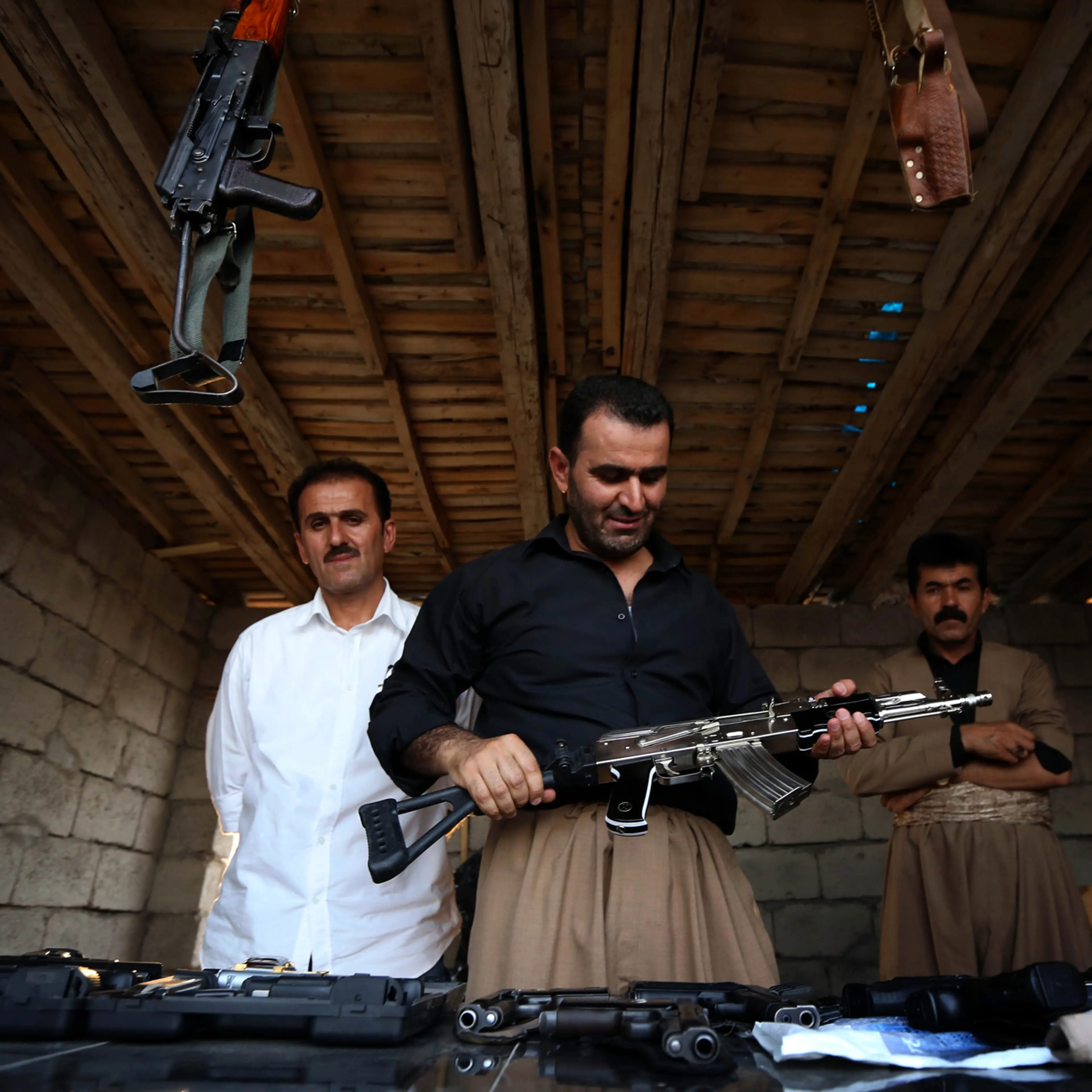 An Iraqi Kurd inspects a machine gun at an arms market in Erbil, the capital of the autonomous Kurdish region of northern Iraq on Aug. 17, 2014.