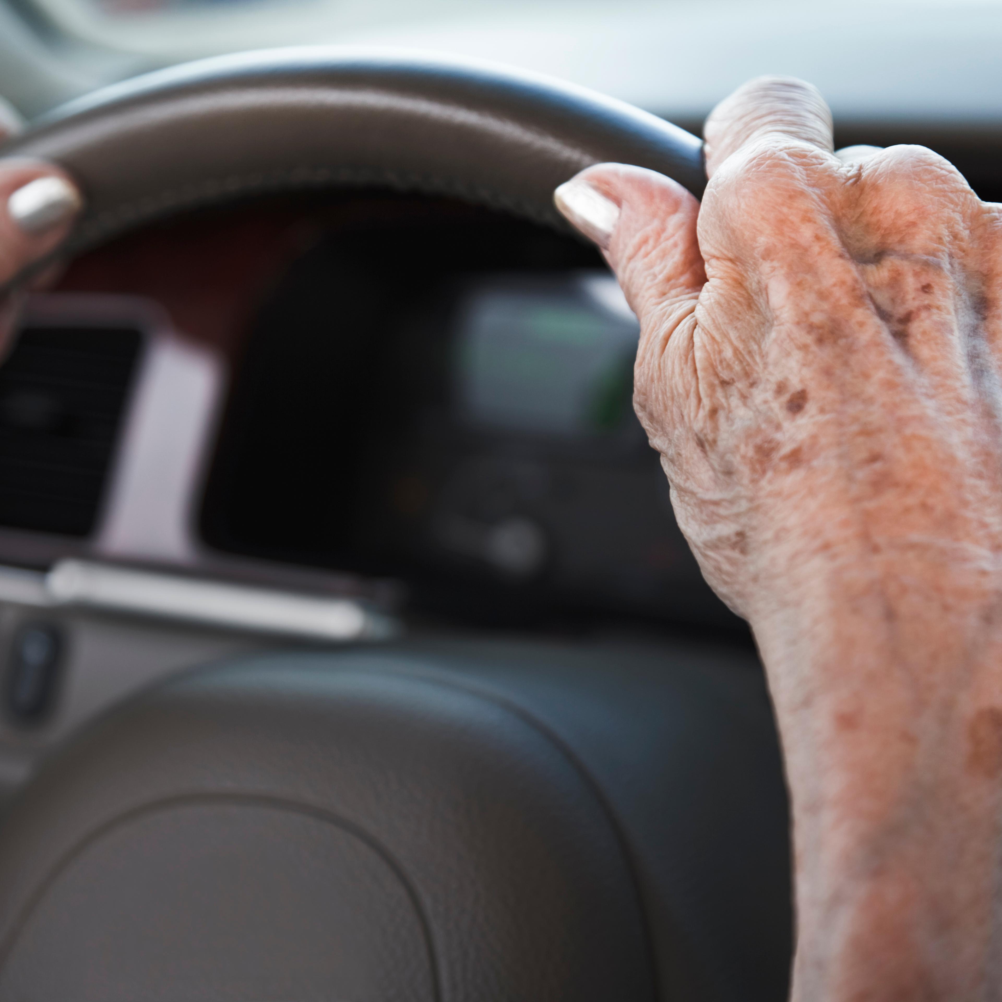 senior woman hands on steering wheel