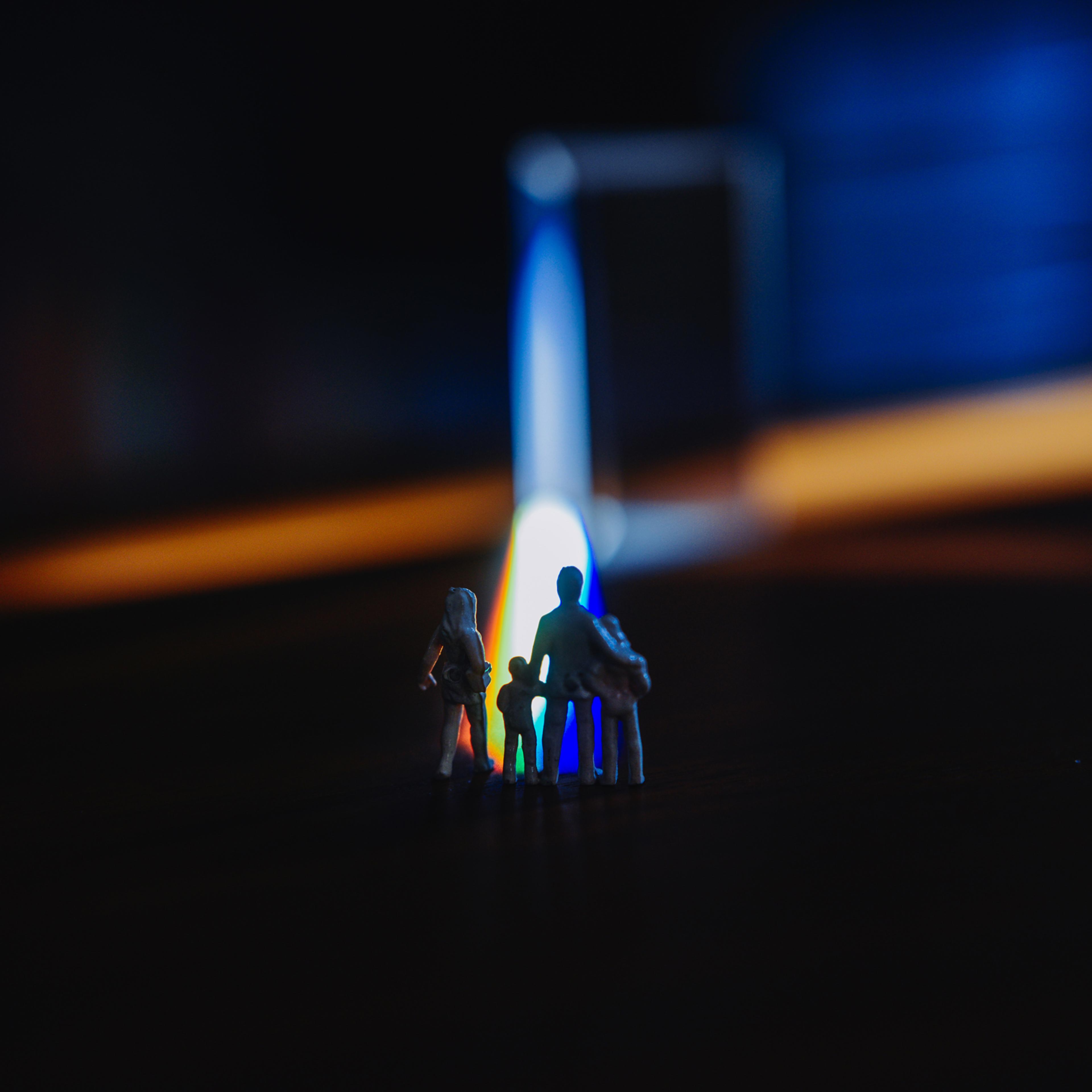 Plastic figurines standing in of light beam.