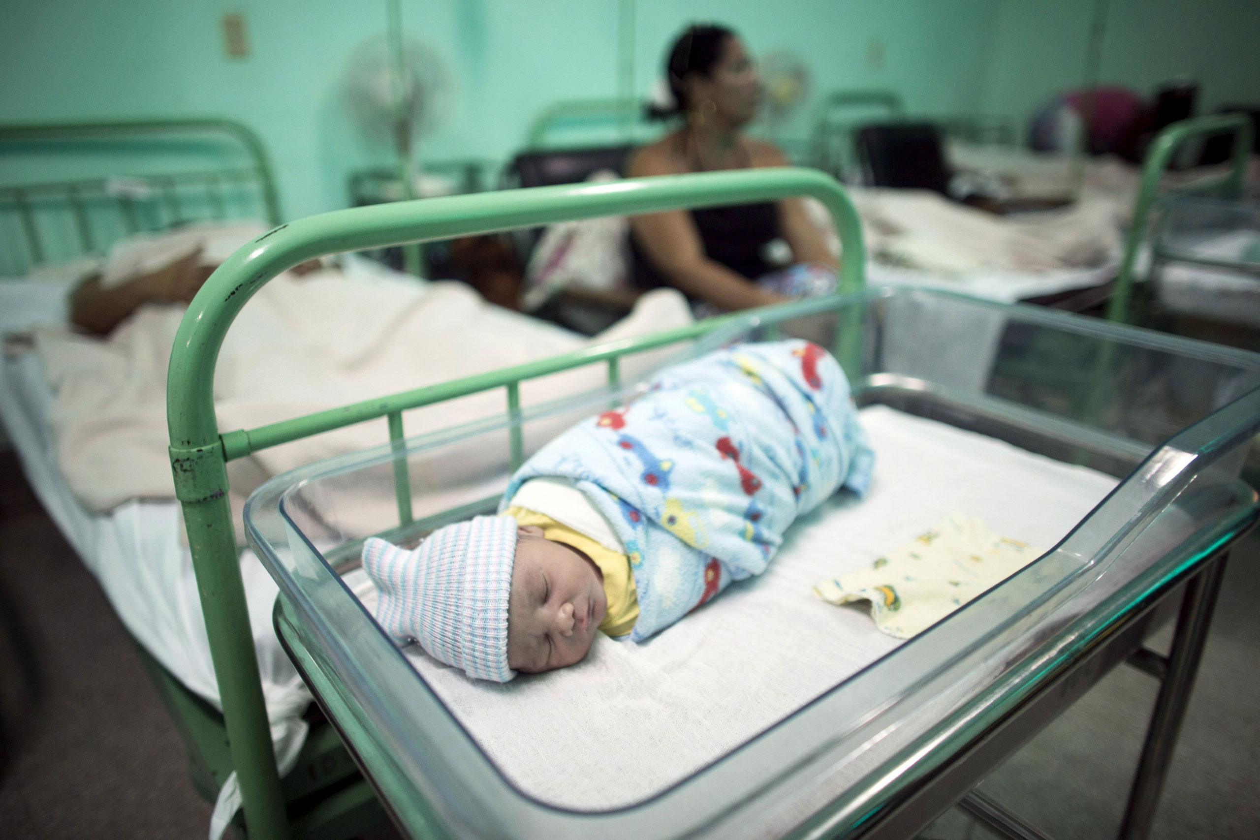 A newborn baby rests beside his mother Dailyn Fleite at the Ana Betancourt de Mora Hospital in Camaguey, Cuba