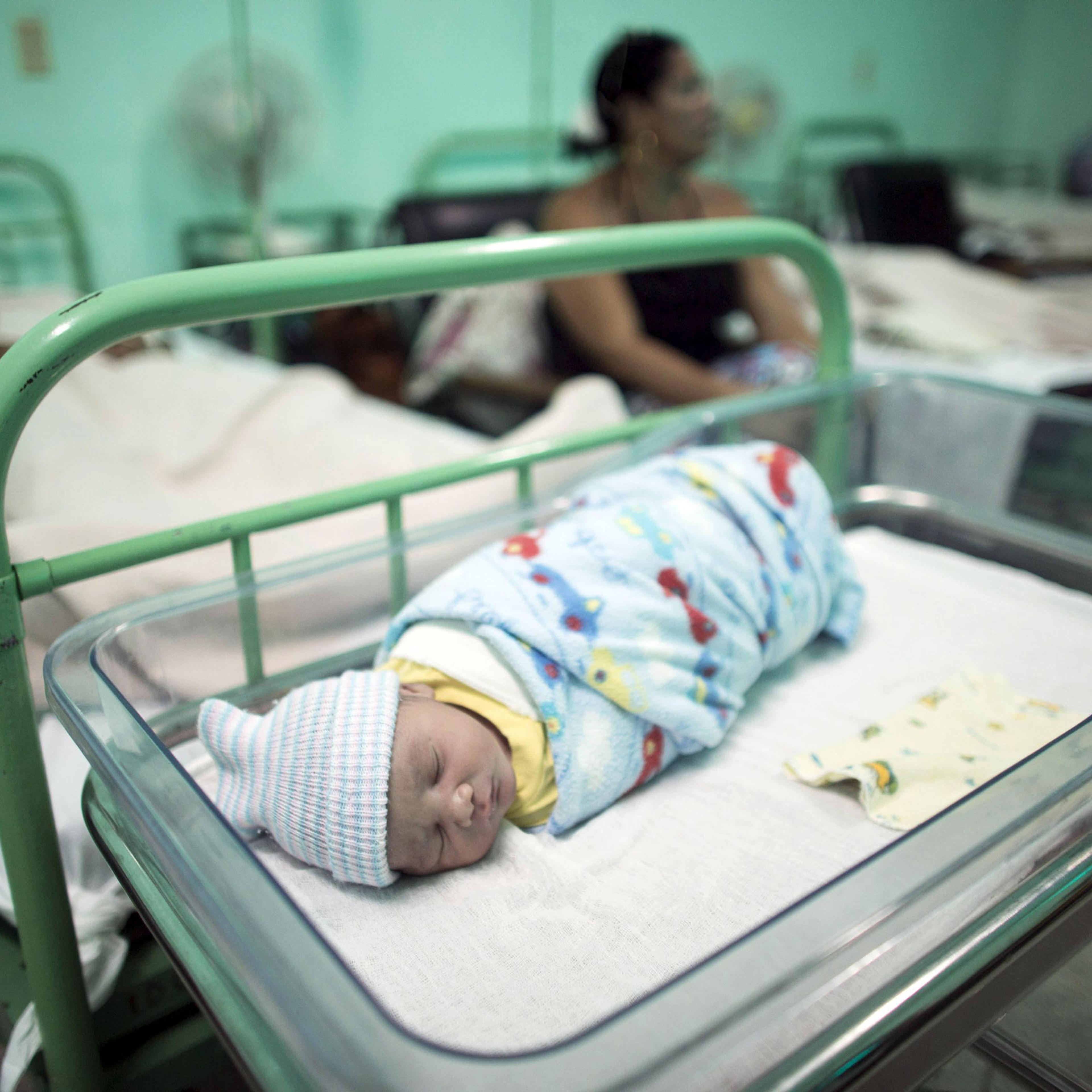 A newborn baby rests beside his mother Dailyn Fleite at the Ana Betancourt de Mora Hospital in Camaguey, Cuba