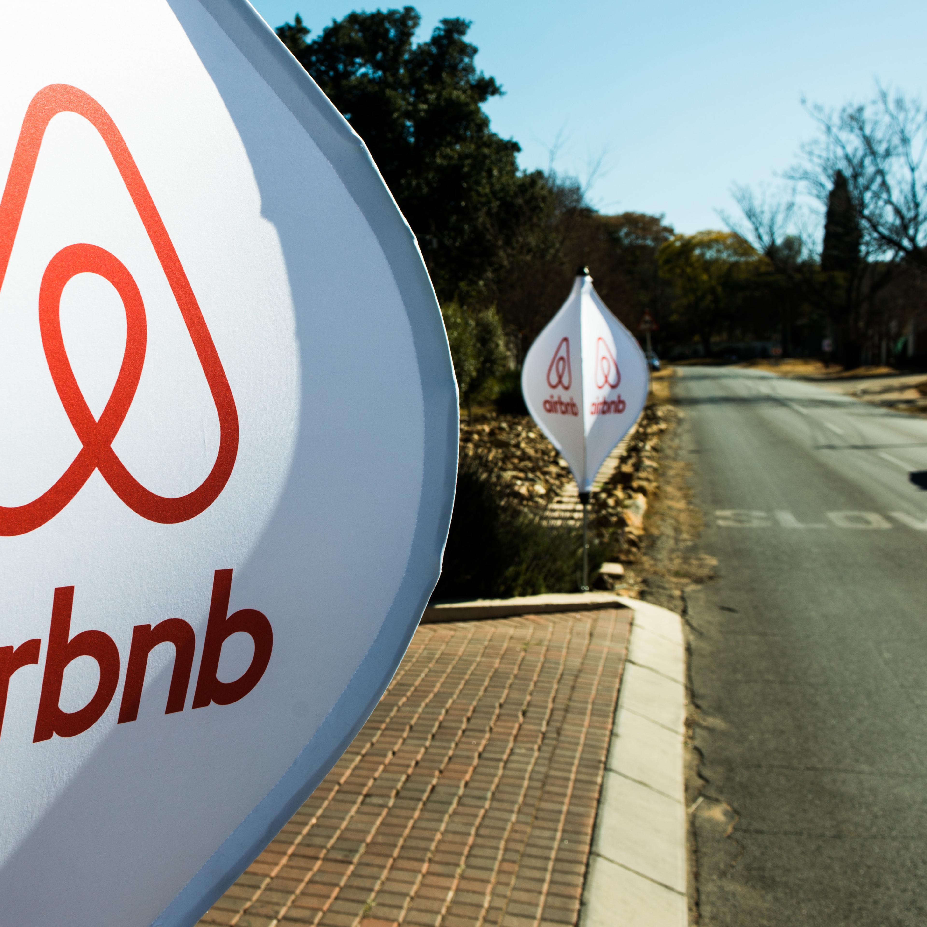 The logos of Airbnb sit on banners displayed outside a media event in Johannesburg on July 27, 2015