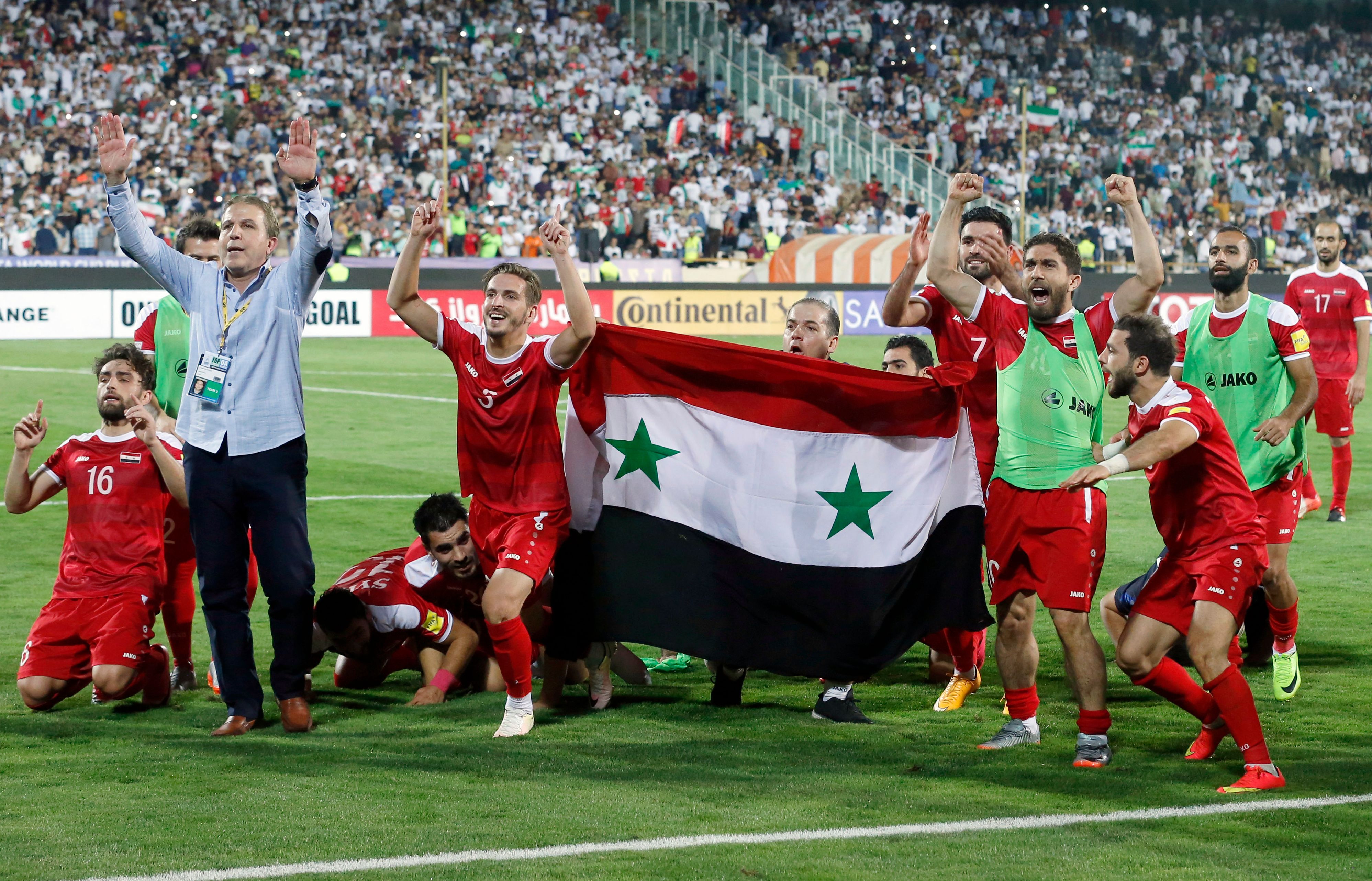 Syrian players celebrate after drawing a FIFA World Cup 2018 qualification match against Iran at Azadi Stadium in Tehran on Sept. 5, 2017. Photo: Atta Kenare—AFP/Getty