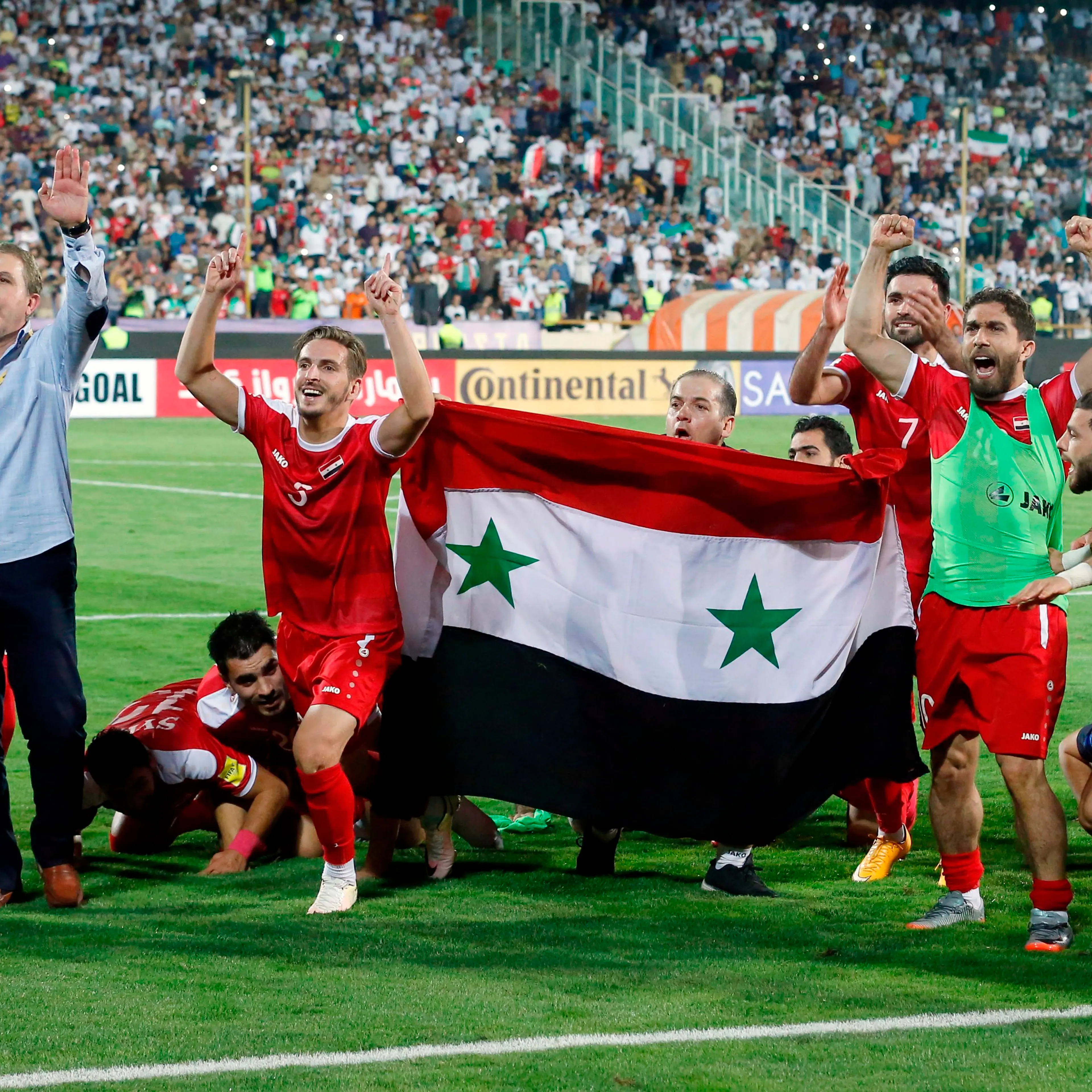 Syrian players celebrate after drawing a FIFA World Cup 2018 qualification match against Iran at Azadi Stadium in Tehran on Sept. 5, 2017. Photo: Atta Kenare—AFP/Getty