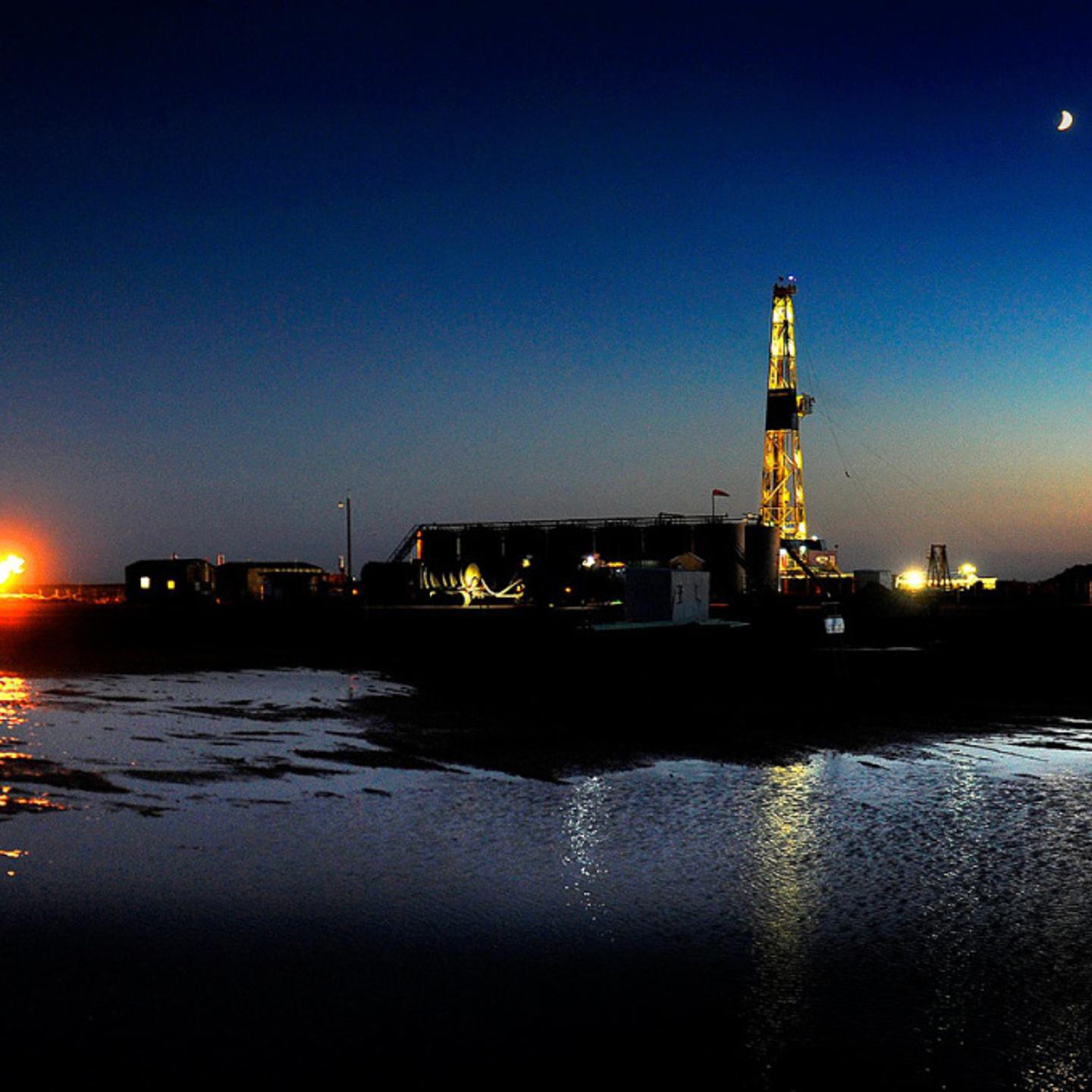 An oil drilling rig at dusk near New Town, North Dakota on June 29, 2012.