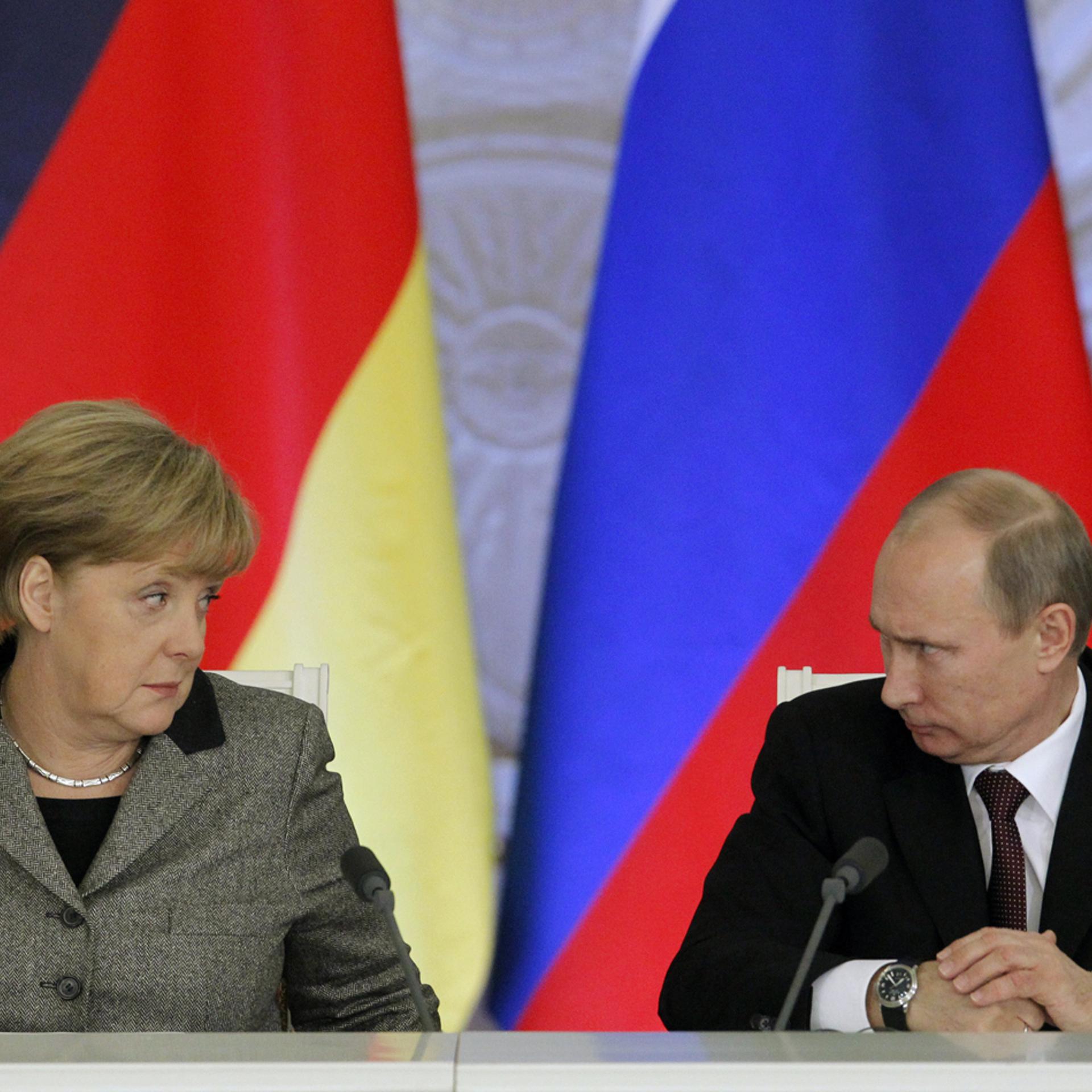 From left: German Chancellor Angela Merkel and Russian President Vladimir Putin answer journalists' questions during a joint news conference in Moscow's Kremlin Nov. 16, 2012.