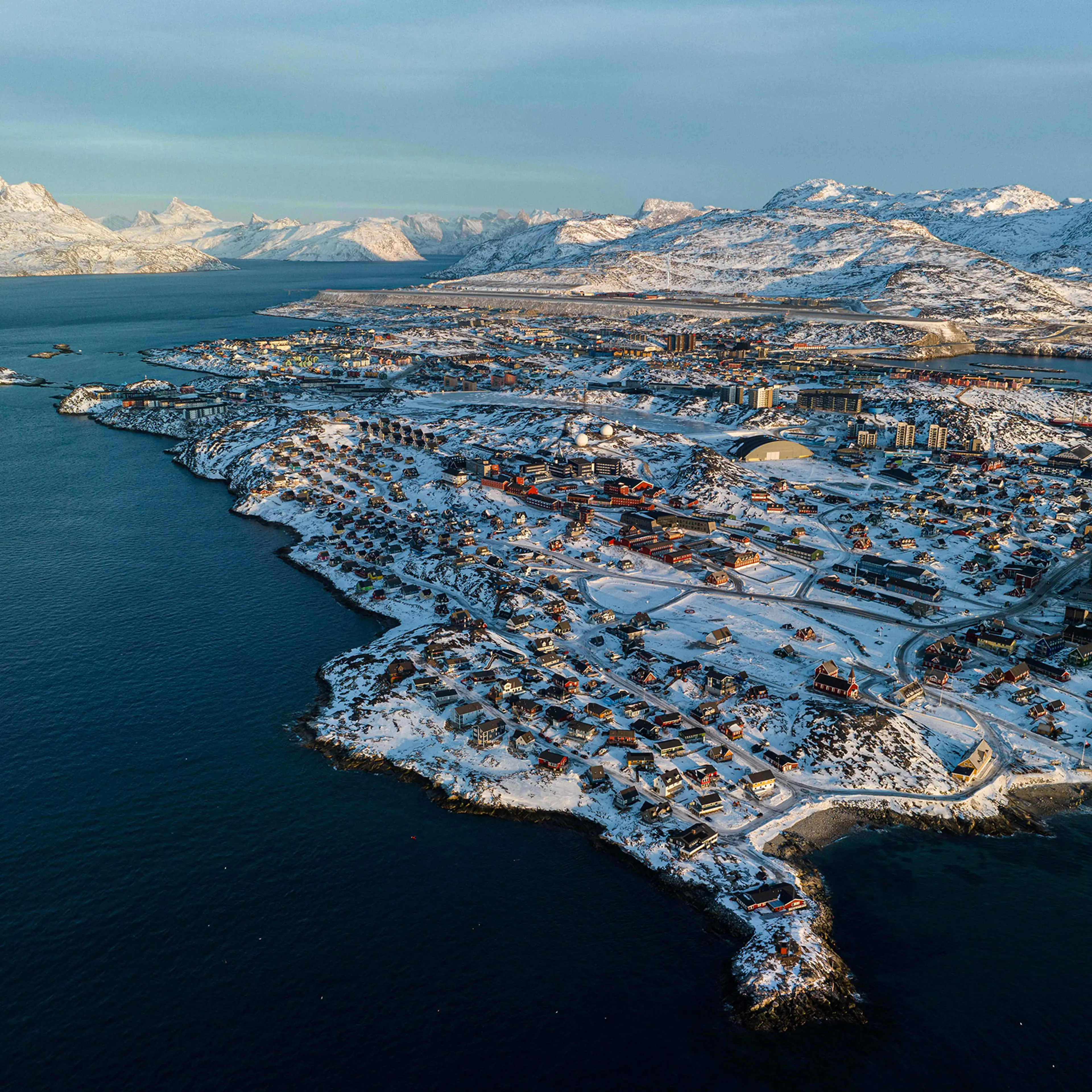 Houses are seen near the coast of a sea inlet of Nuuk, Greenland, on Jan. 25, 2026.