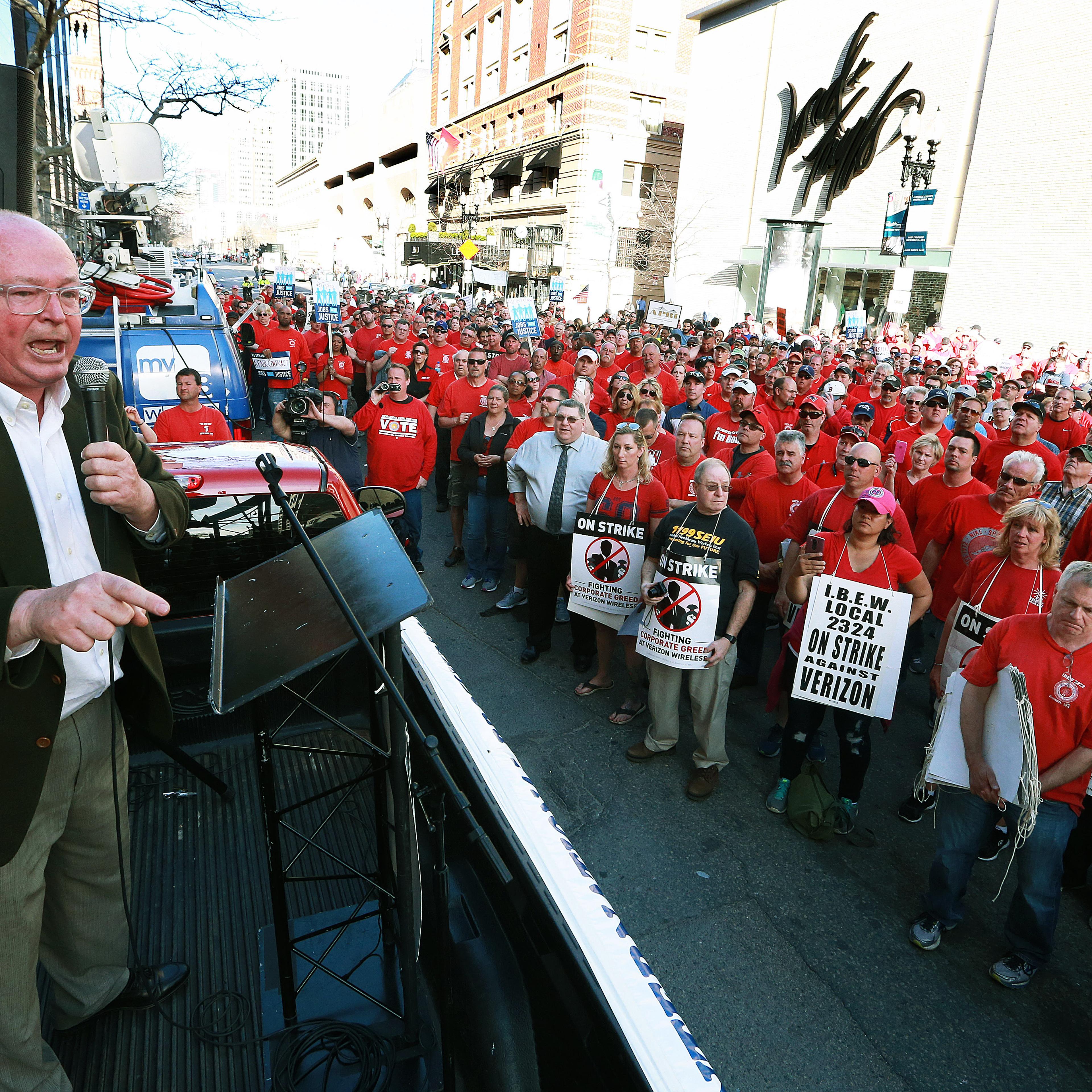 Striking Verizon employees staged a rally in Copley Square, followed by a march to a Verizon Destination Store on Boylston Street, where union officials spoke to the crowd from the back of a pickup truck.
