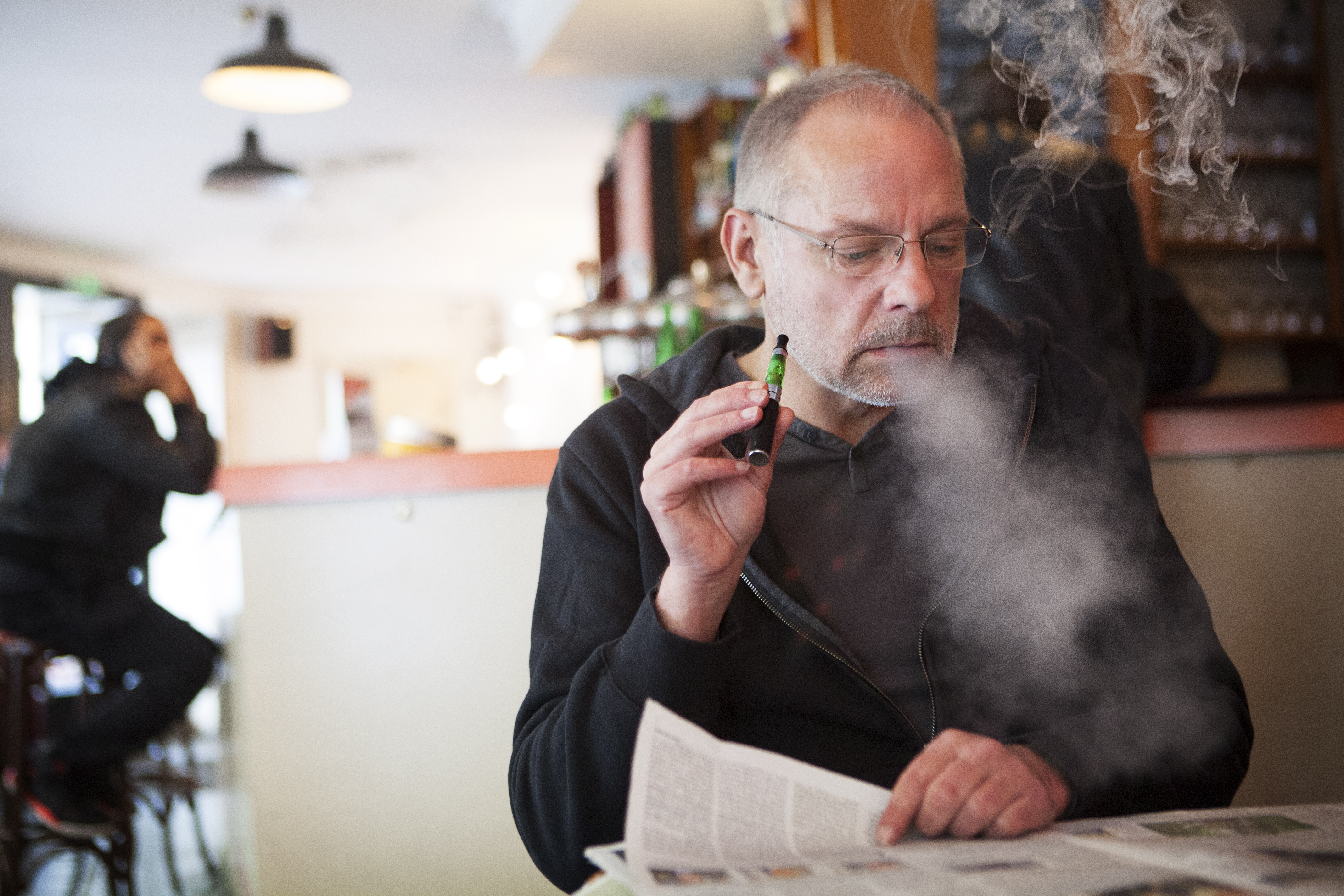 Man smoking e-cigarette in public