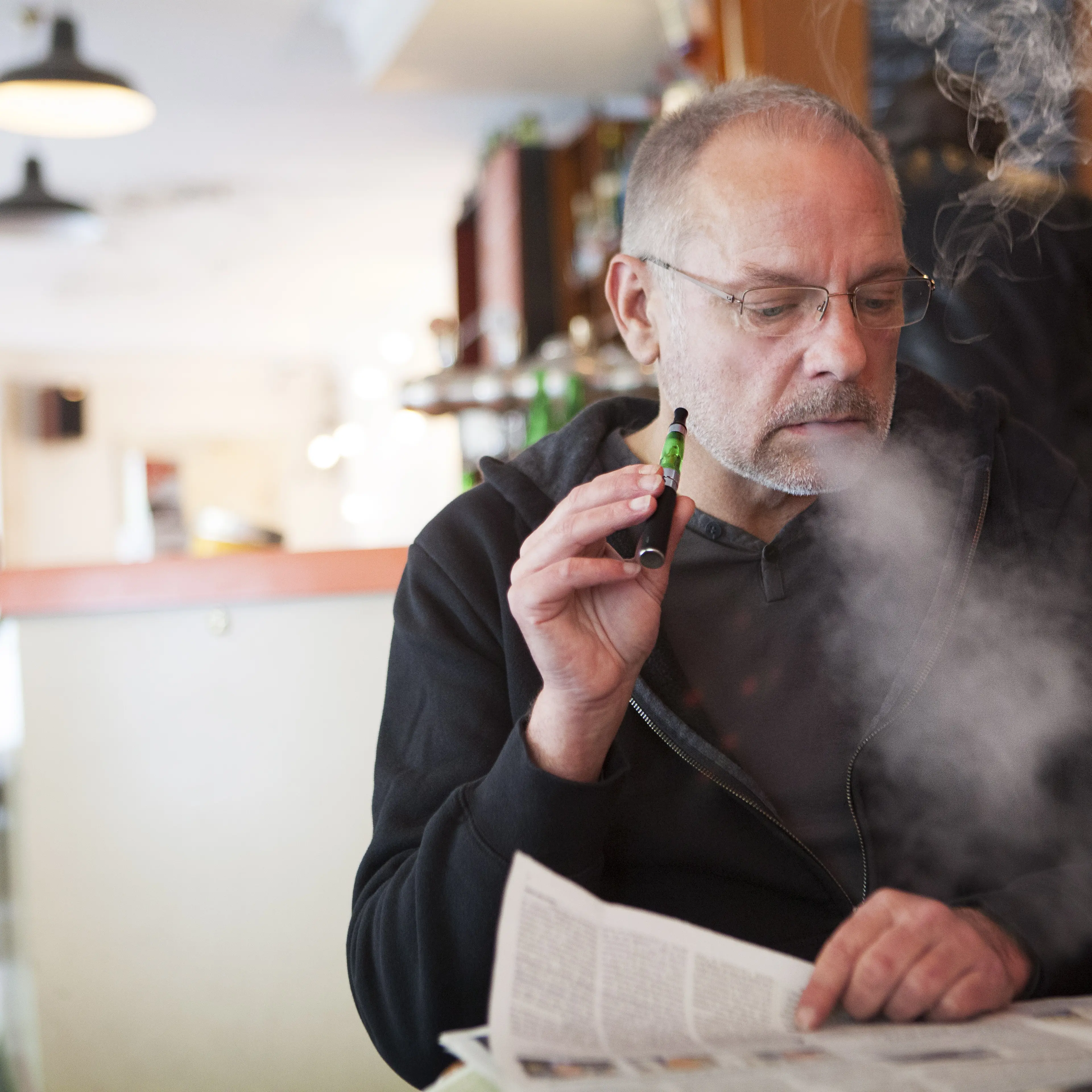 Man smoking e-cigarette in public