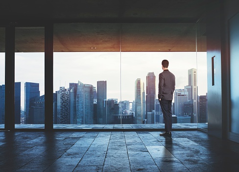 businessman-looking-through-window
